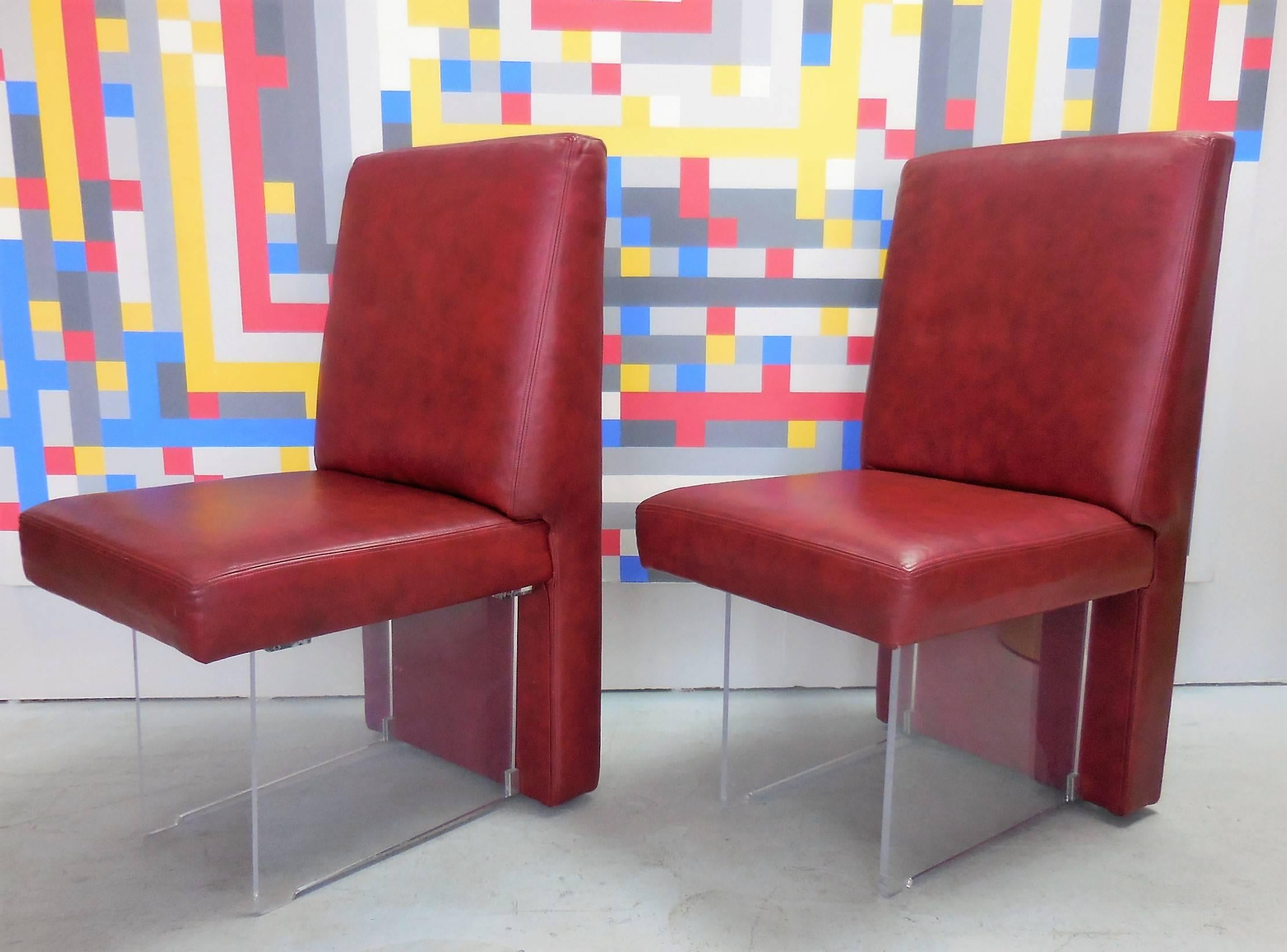 A rare set of eight vintage omnibus dining chairs by Vladimir Kagan. The design is inventive and comfortable, a true icon of modern furniture design. Retain the original red leather upholstery.