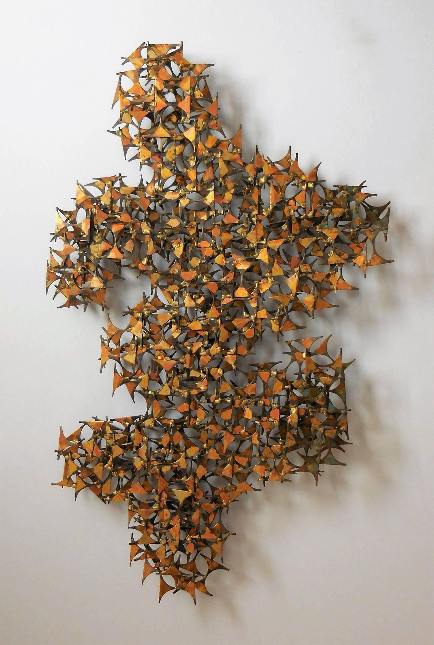 A large wall sculpture in the style of Marc Weinstein. Intricate steel construction with gilt patina. 