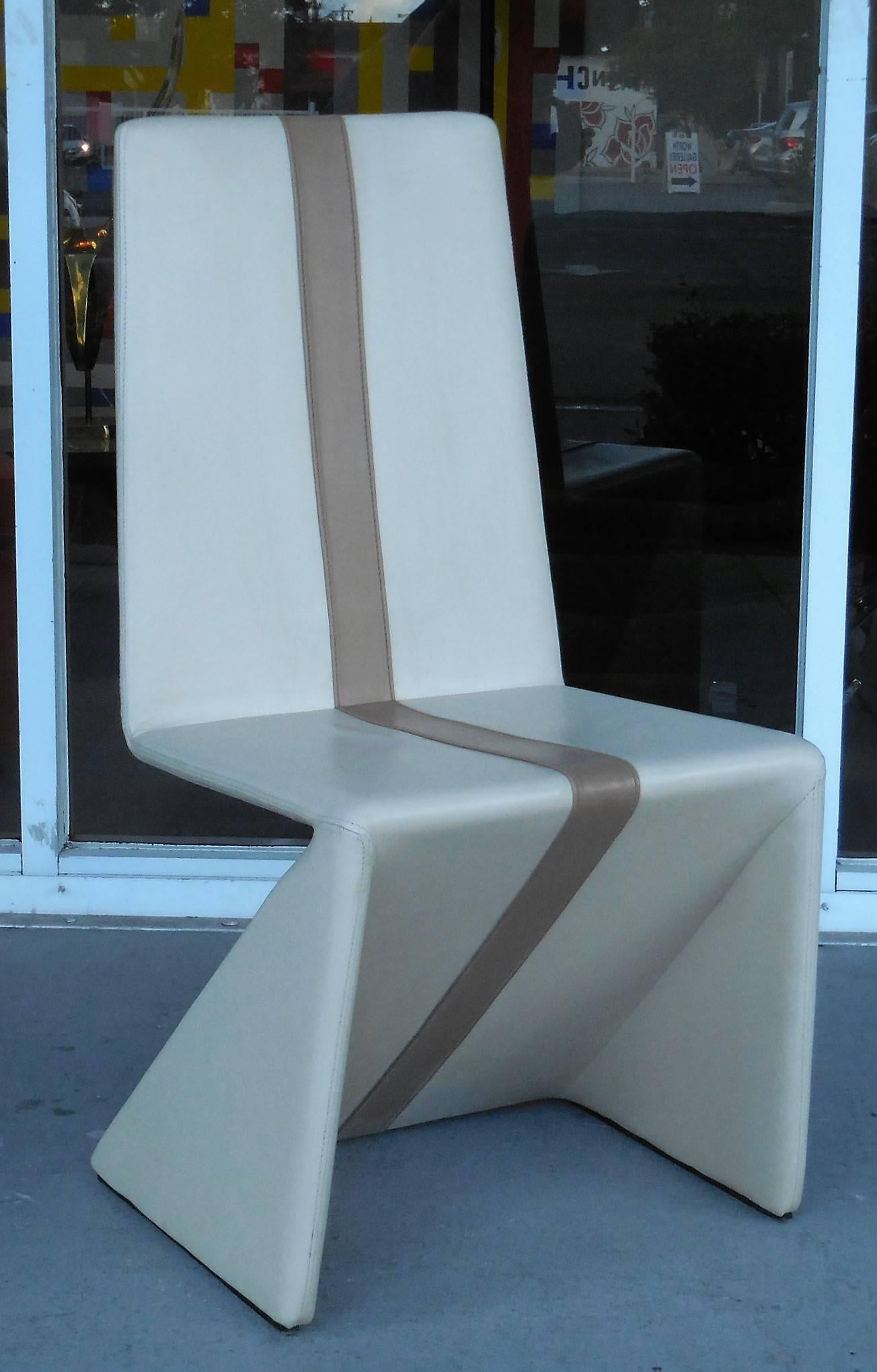 A set of 1970s dining chairs. Simple origami like design. Color is light taupe with a darker band running in the center. Attributed to Maison Jansen.