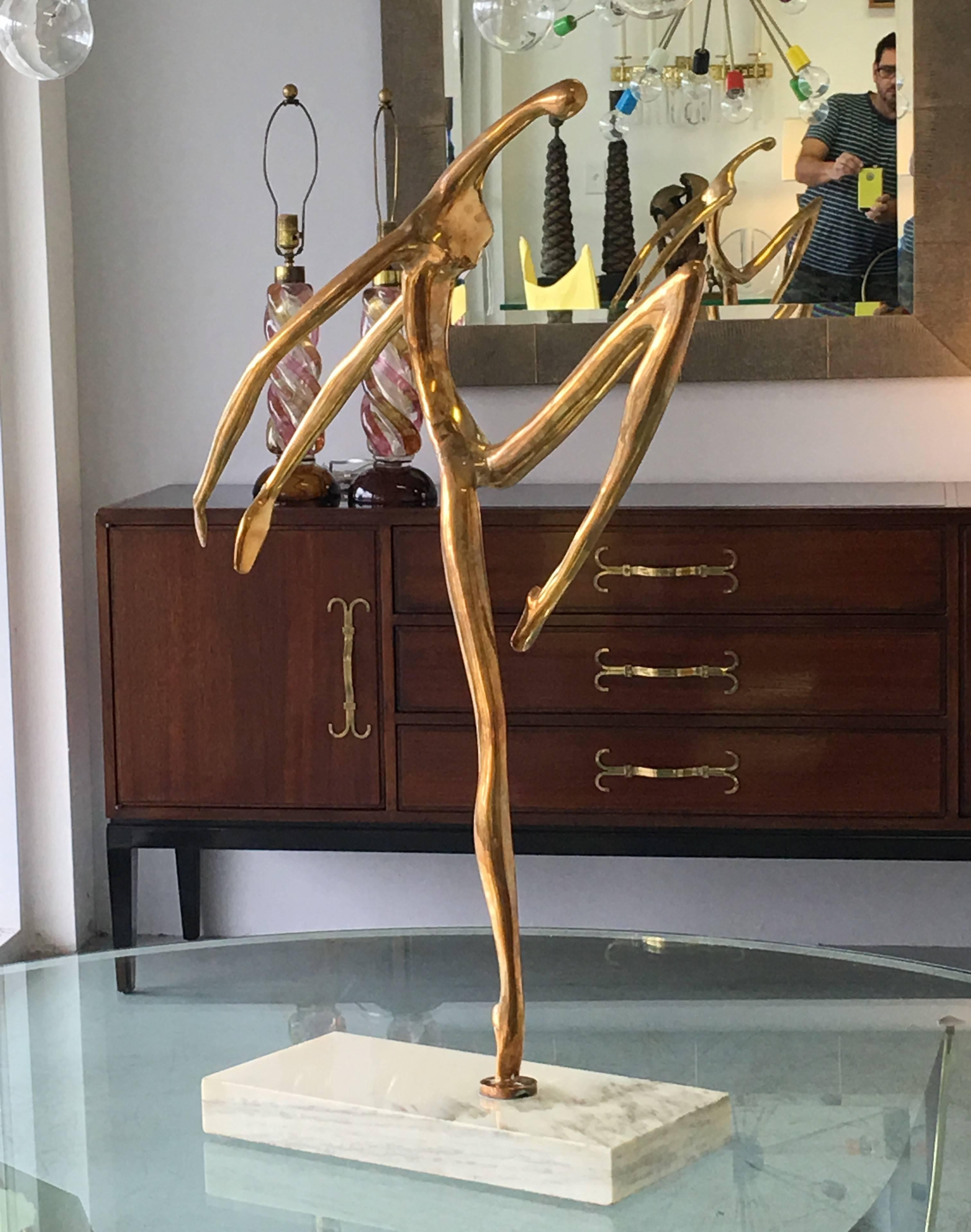 A large abstract bronze sculpture by noted Cuban artist Manuel Carbonell. It is a large stylized sculpture. Although the basic attributes of the figure are apparent, the shapes are abstracted to a more essential biomorphic volumes. Signed with
