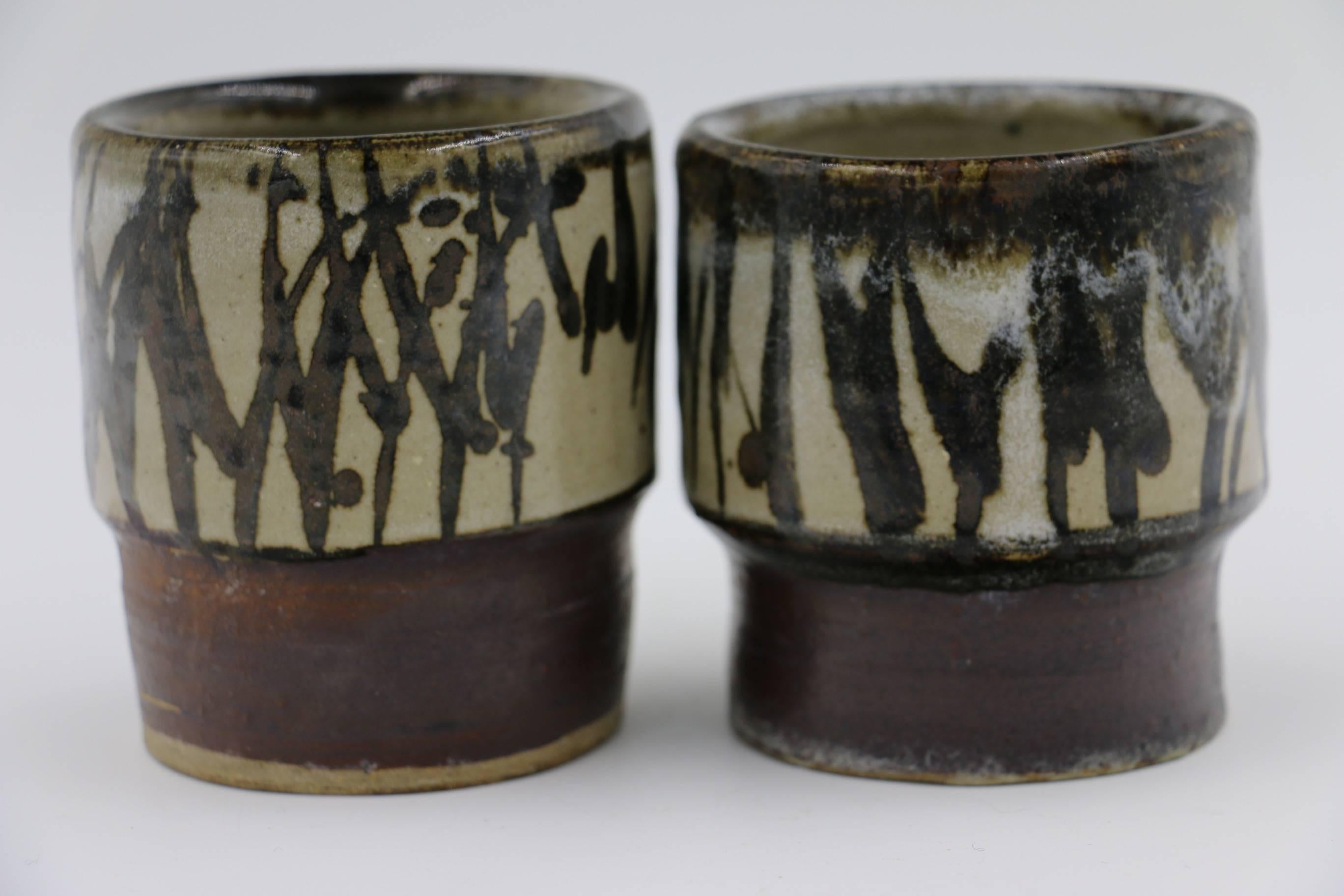 Kenneth Price was an American artist who uncovered the surprising possibilities of ceramics as sculpture. He is best known for his abstract shapes constructed from fired clay. These are an unusual pair of cups, signed by the artist.