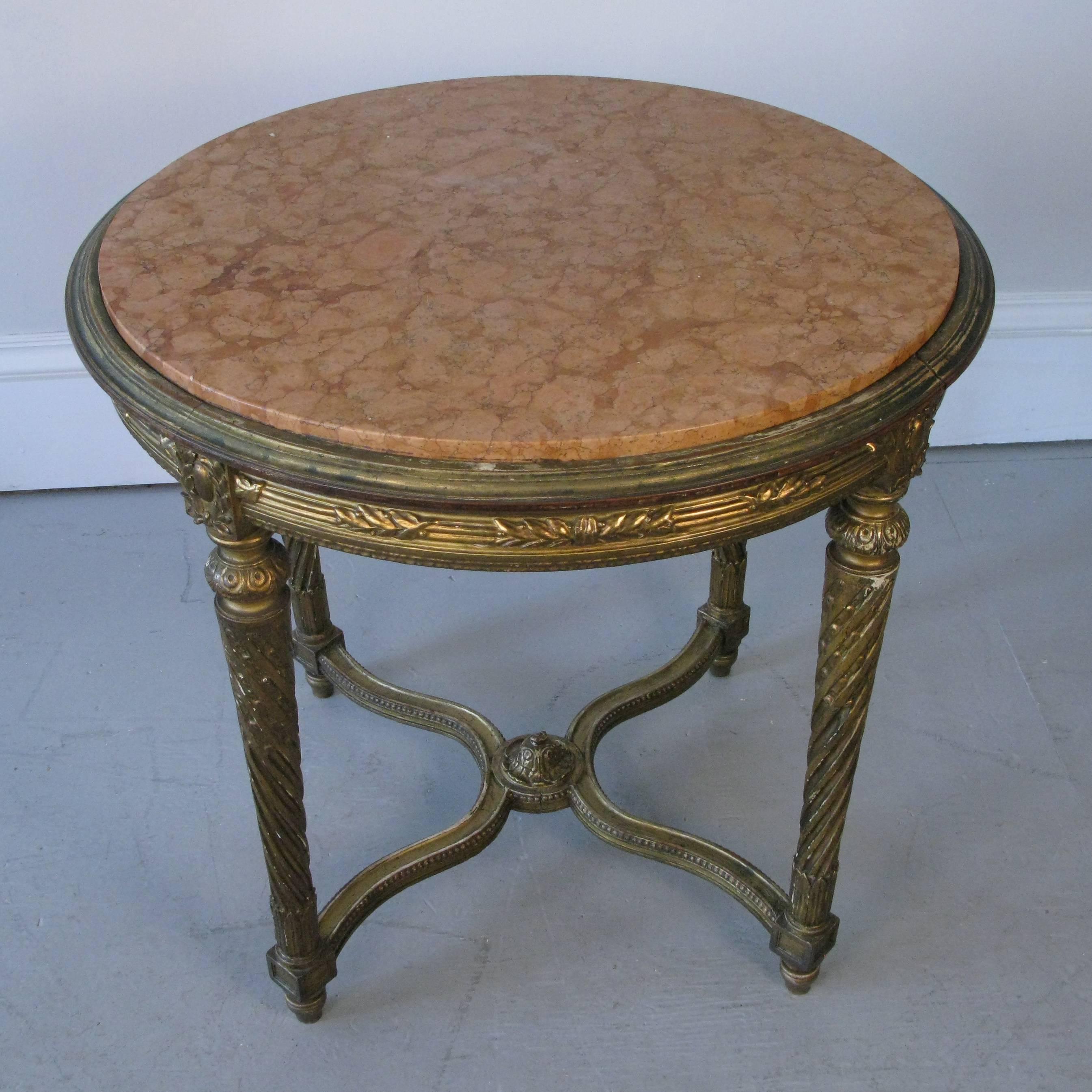 A quite beautiful 19th century 1870s-1880s Italian giltwood and rose marble round table. Aged to a soft rich patina. Turned legs an relief carving.