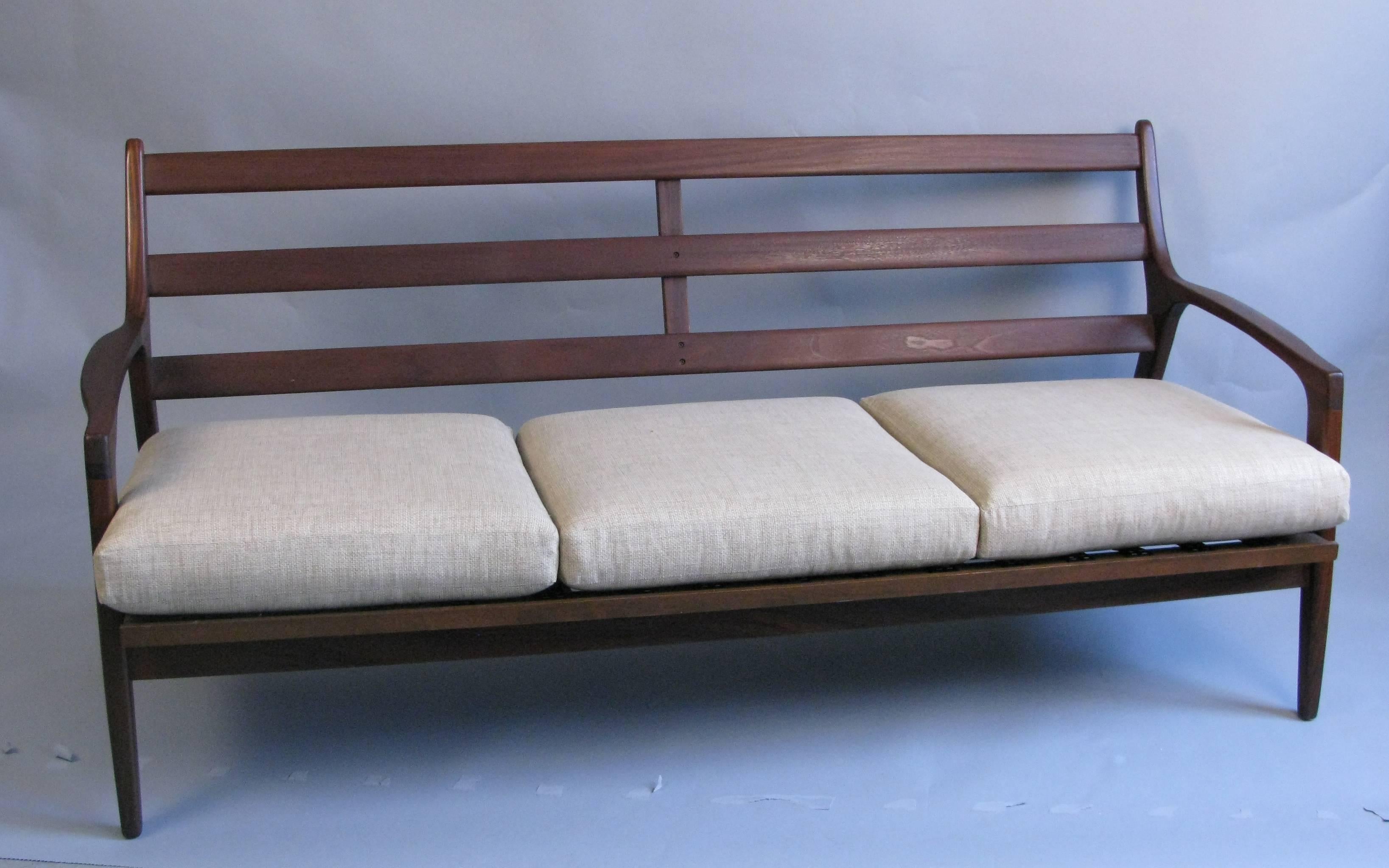 A good looking mid century mahogany sofa. Very nice lines and very sturdy construction. The sofa is quite comfortable. I believe the sofa to be American in design.