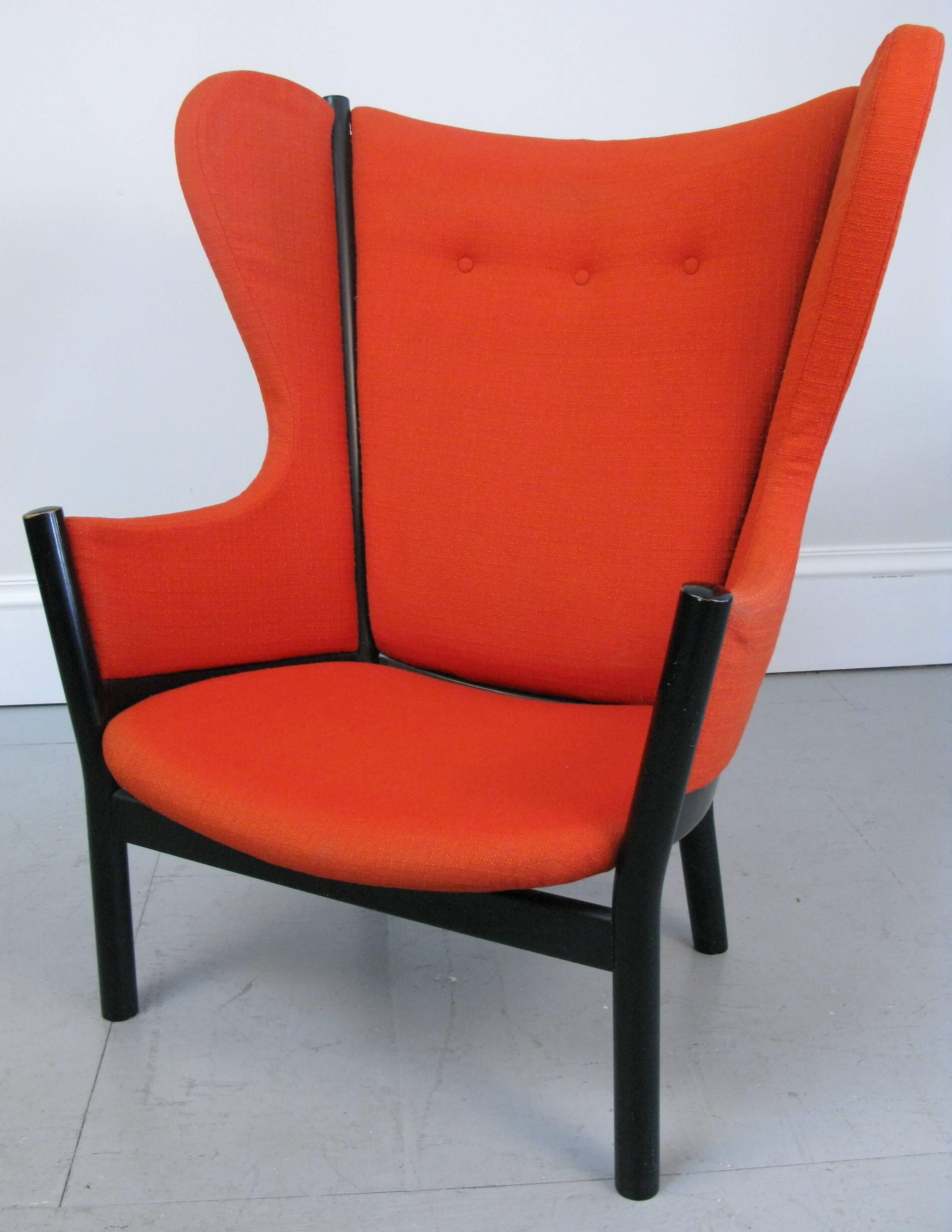 A fantastic Mid-Century Danish wing chair with France and Son and John Stuart labels. The design is great so fluid and yet so simple. The chairs has it's original red upholstery. The foam rubber has solidified.