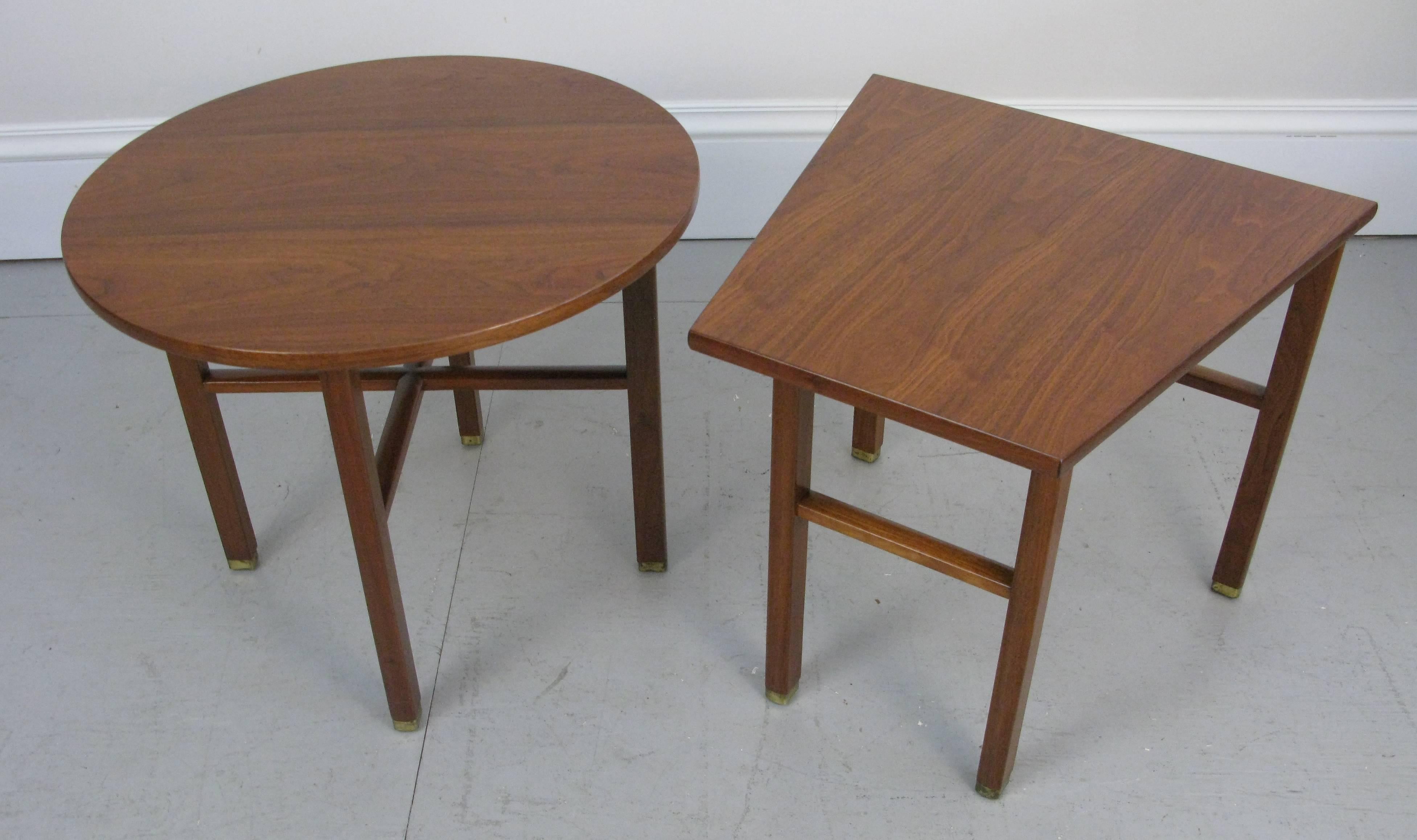 These two 1950s end or side tables had been used as a pair on either end of a sofa. The geometry of the two shapes is wonderful. The walnut has been newly finished.