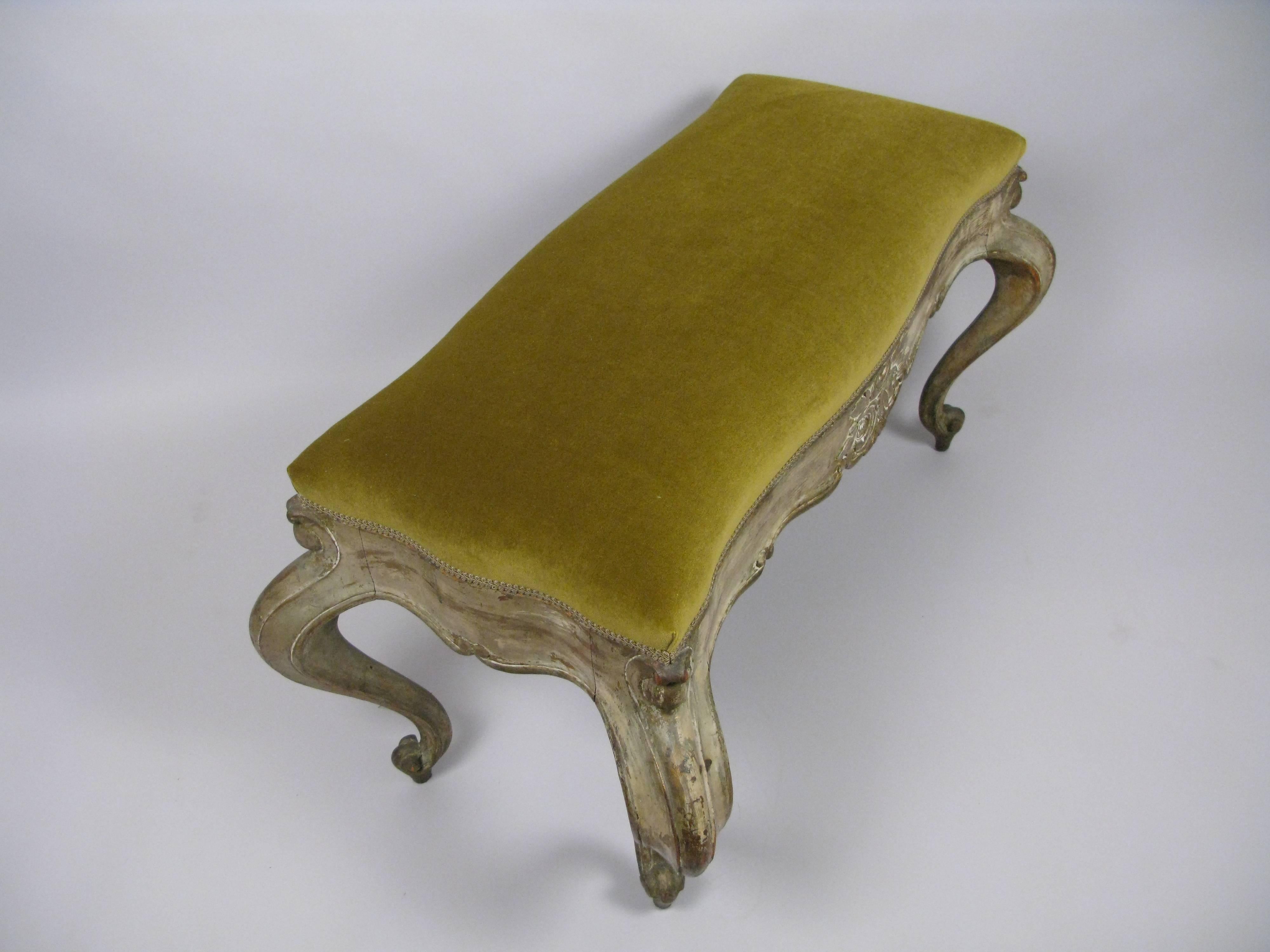 An exuberant 19th century Venetian upholstered bench is a presence in any room. Recently upholstered in brushed pear green velvet.