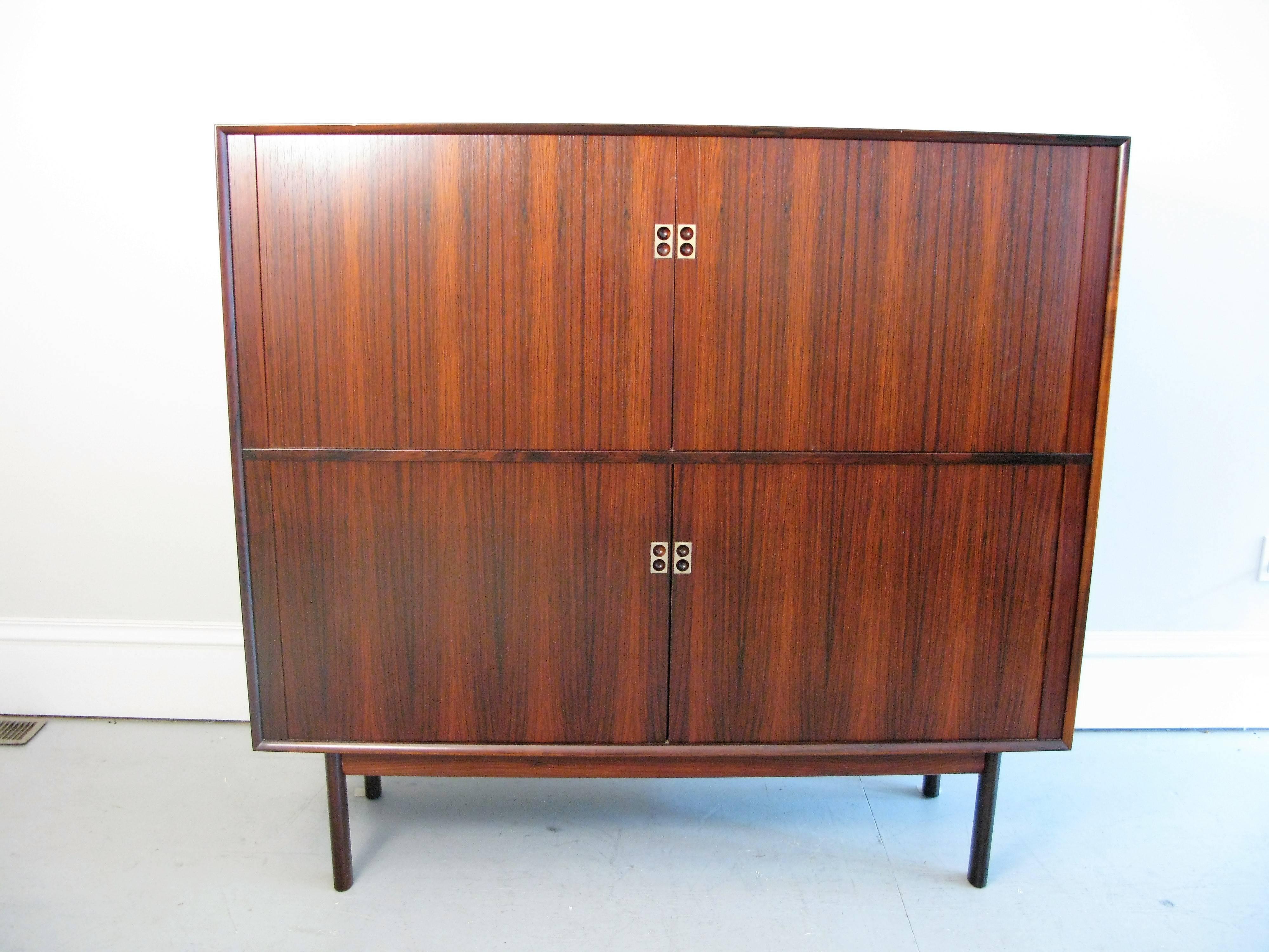 Beautiful Danish rosewood cabinet with tambout doors designed by Arne Vodder for Sibast. Label inside cabinet.