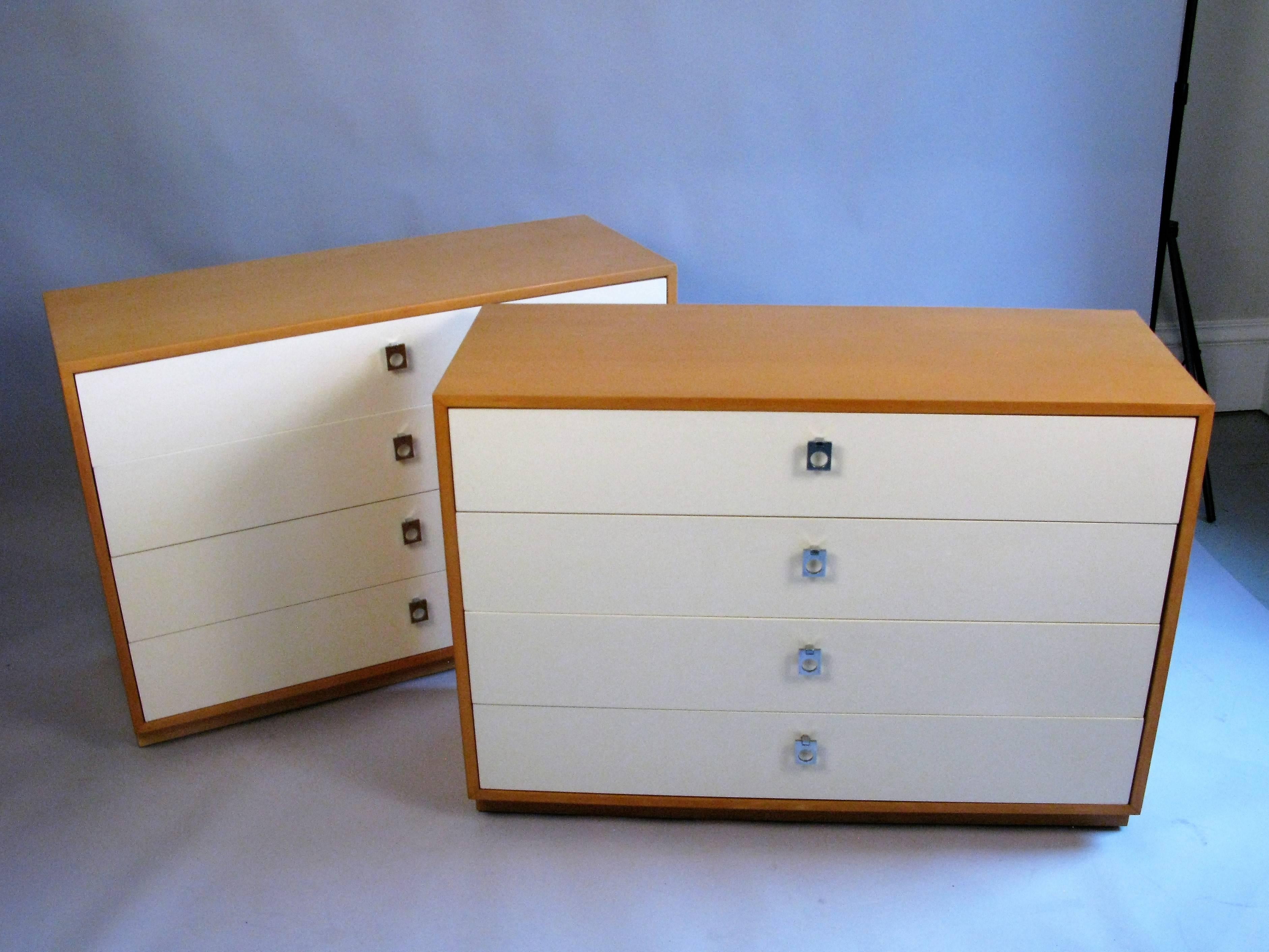 A pair of 1960s modern four drawer chests by Founders. The chests are birch and lacquered fronts with original chrome pulls. Label inside drawer.