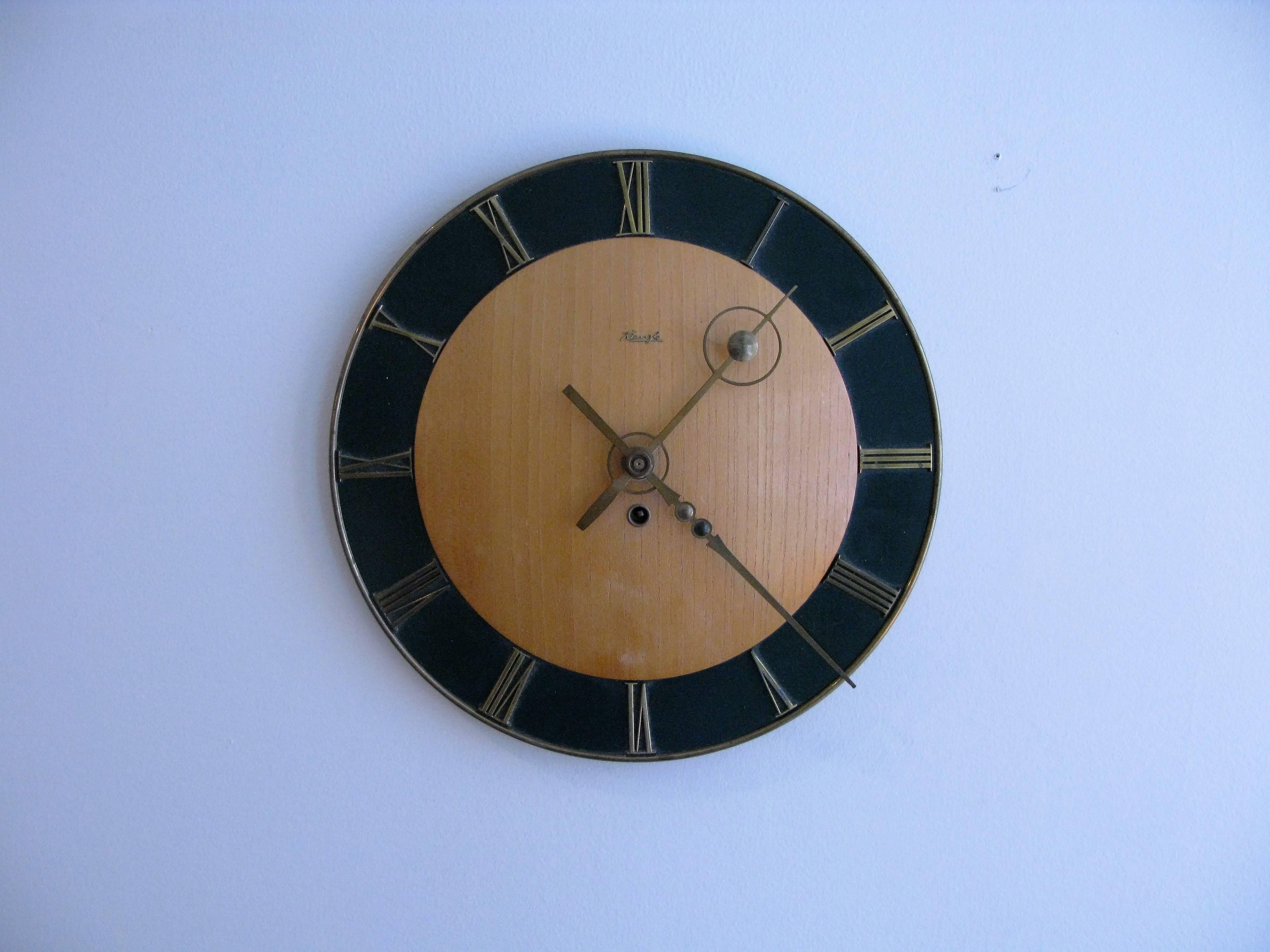 A very nice 1950s key wound wall clock by German maker Kienzle. Runs about 5-6 days before re winding. Keeps accurate time.