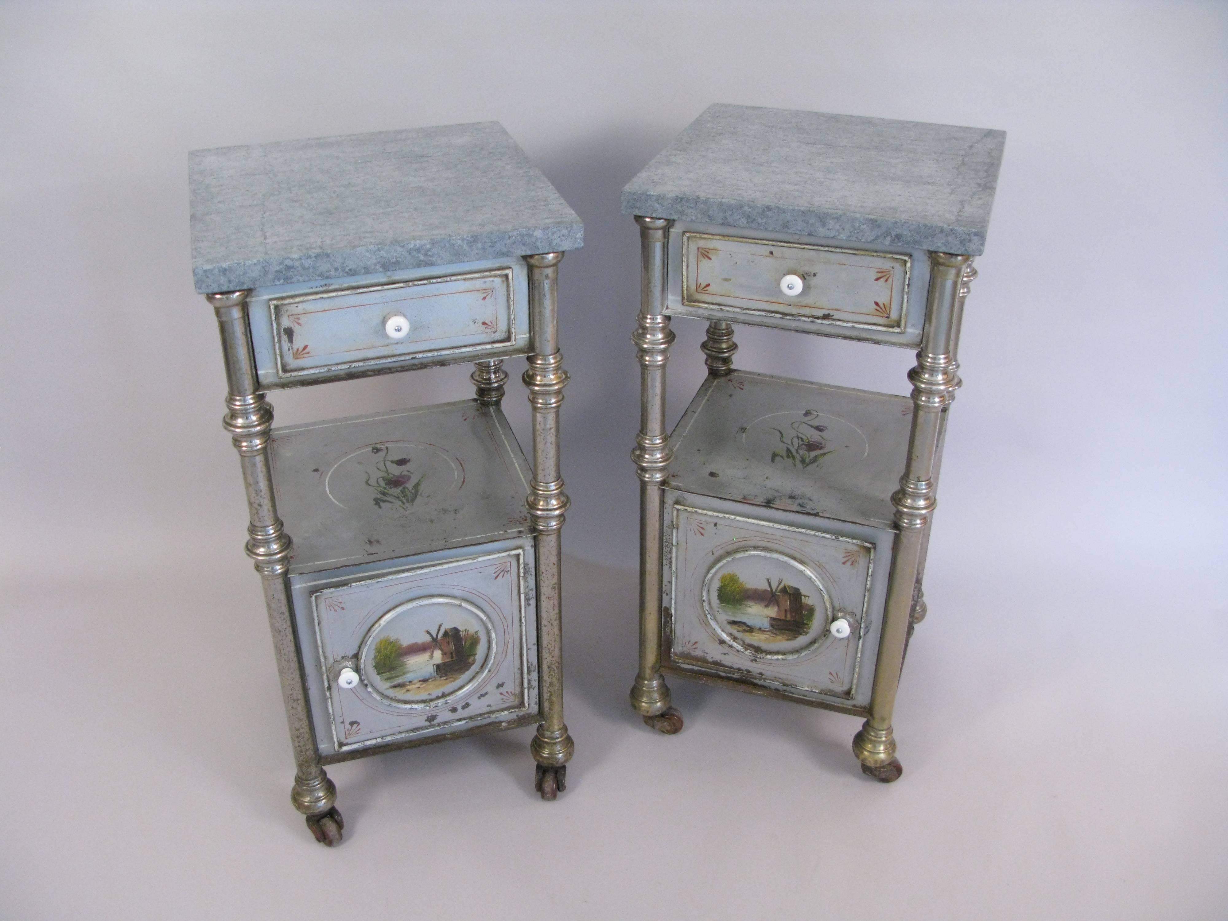Striking pair of late 19th century bedside decorated metal cabinets with Russian labels on the back. The gray marble tops are later. The stands have been cleaned, but have paint losses, surface rust, and usage. That also means great aged patina. A