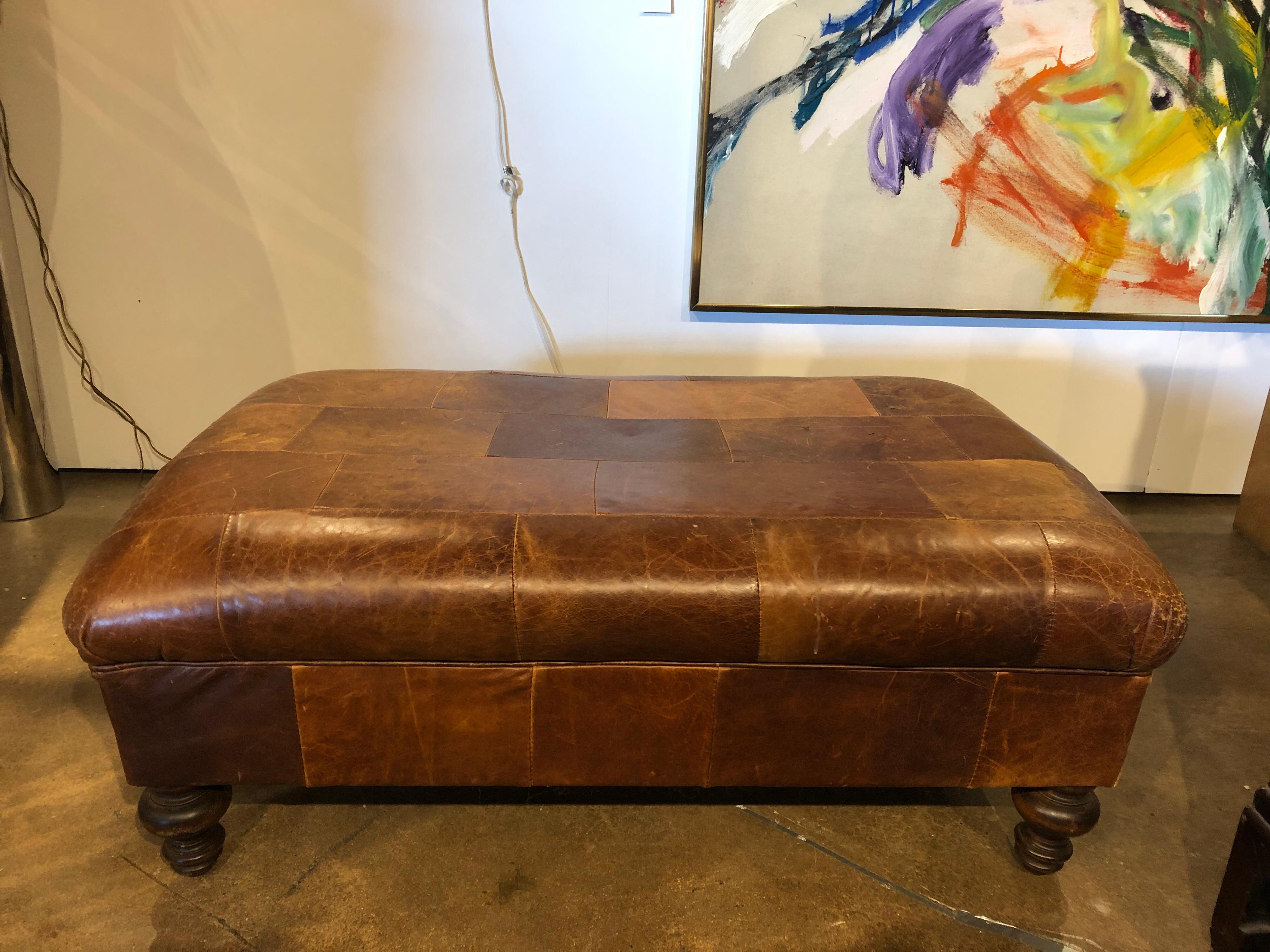 Vintage English leather patchwork ottoman or bench.