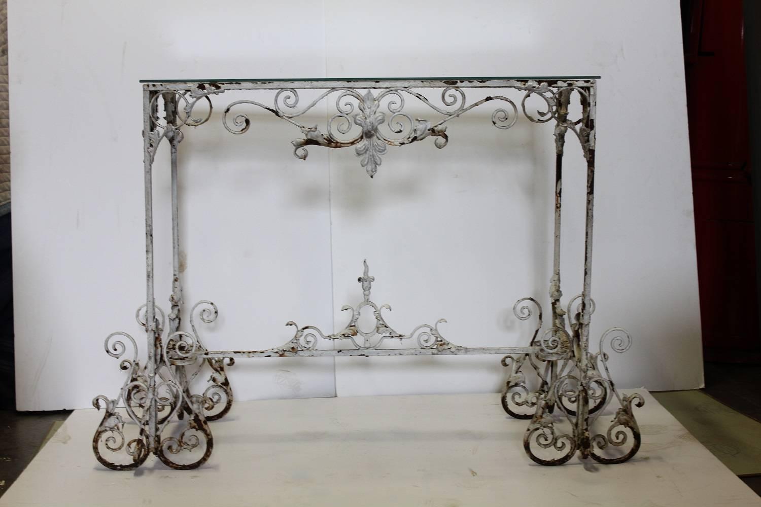 Antique French decorative iron garden console table with glass top.