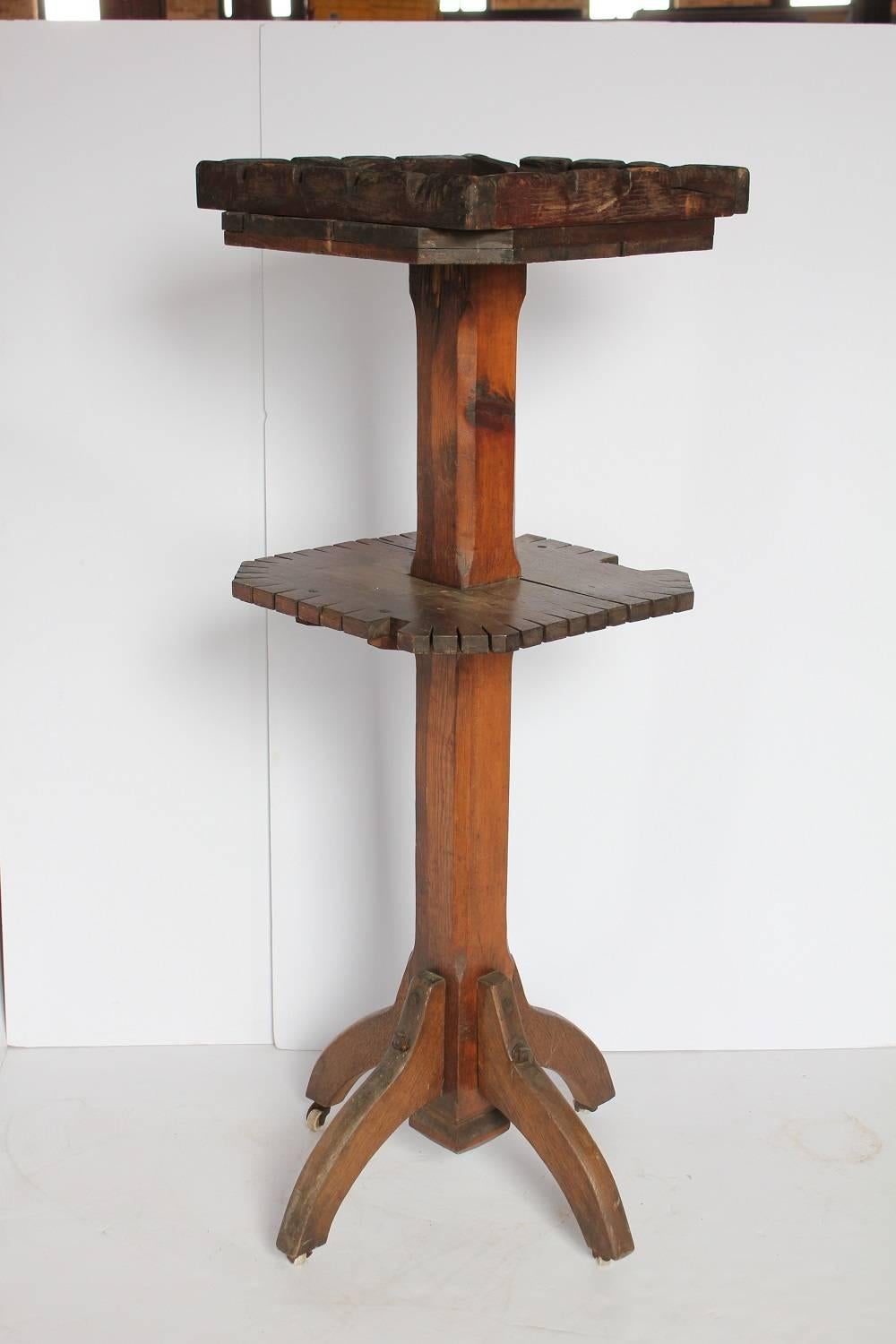 Antique dry goods store display wood stand on wheels.