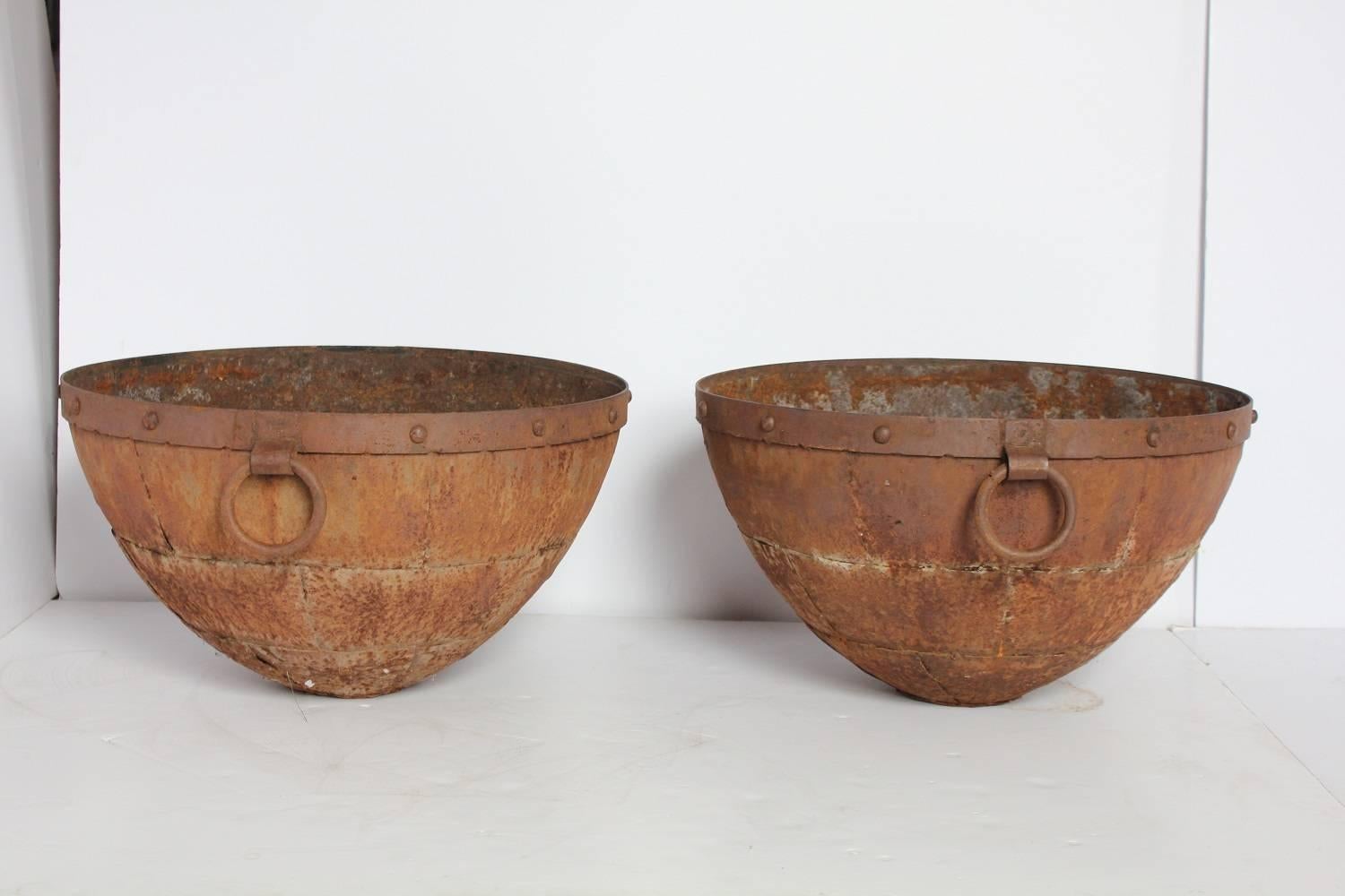Large antique iron bowls.