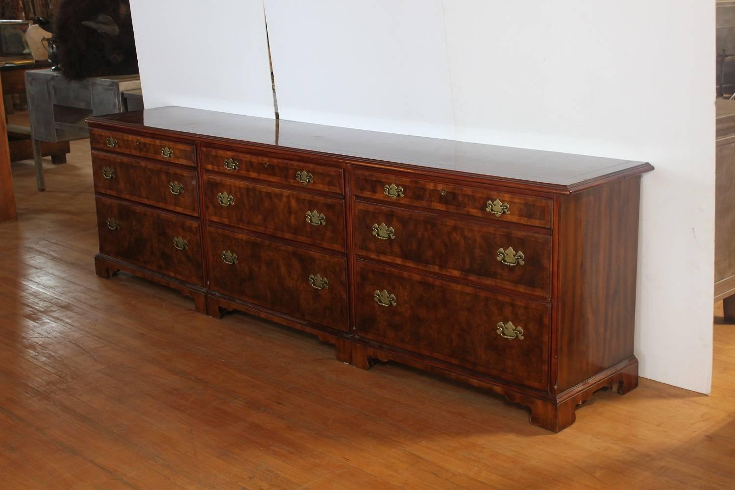 9ft long walnut credenza by Widdicomb with brass hardware. It has brass designer tag.