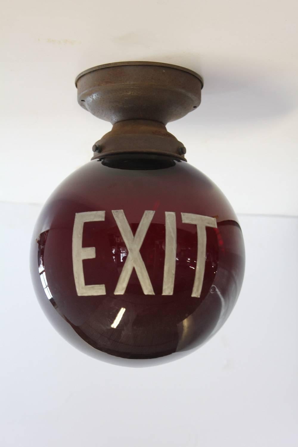 1930s American round ruby red exit light. Newly rewired and in working condition.