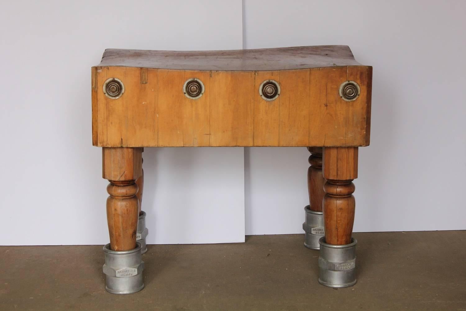 Unusual antique American butcher block table with adjustable height.