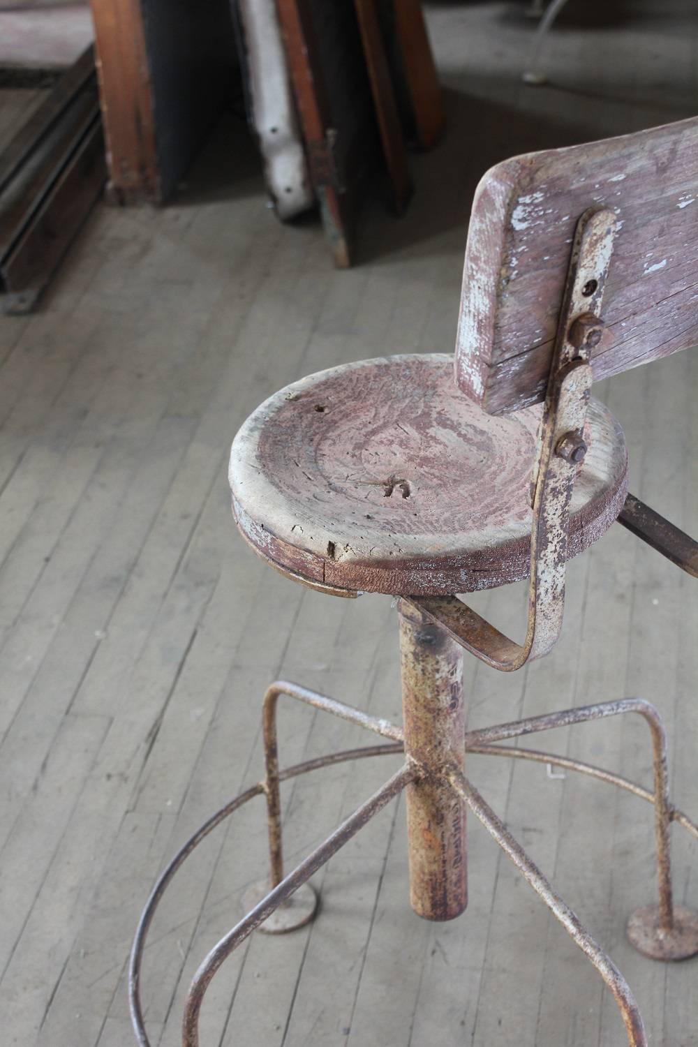 1930s American artist's stool with metal base and wood seat and wood back.