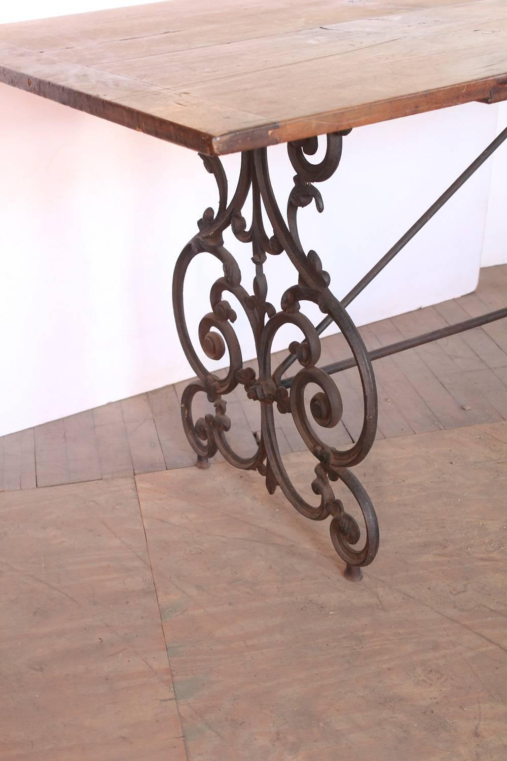 American wrought iron and wood base table, circa 1900s.