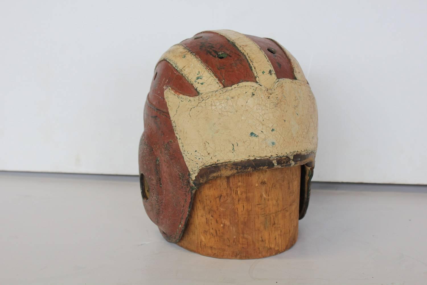 Antique football leather helmet with wood hat mold.