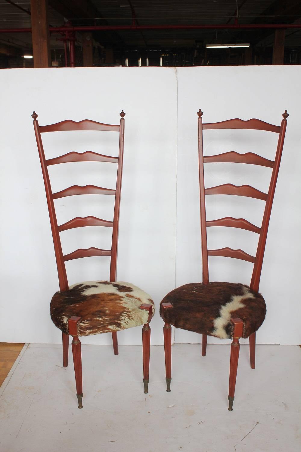 Mid-Century Italian high back cowhide and wood chairs by Meroni & Fossati.