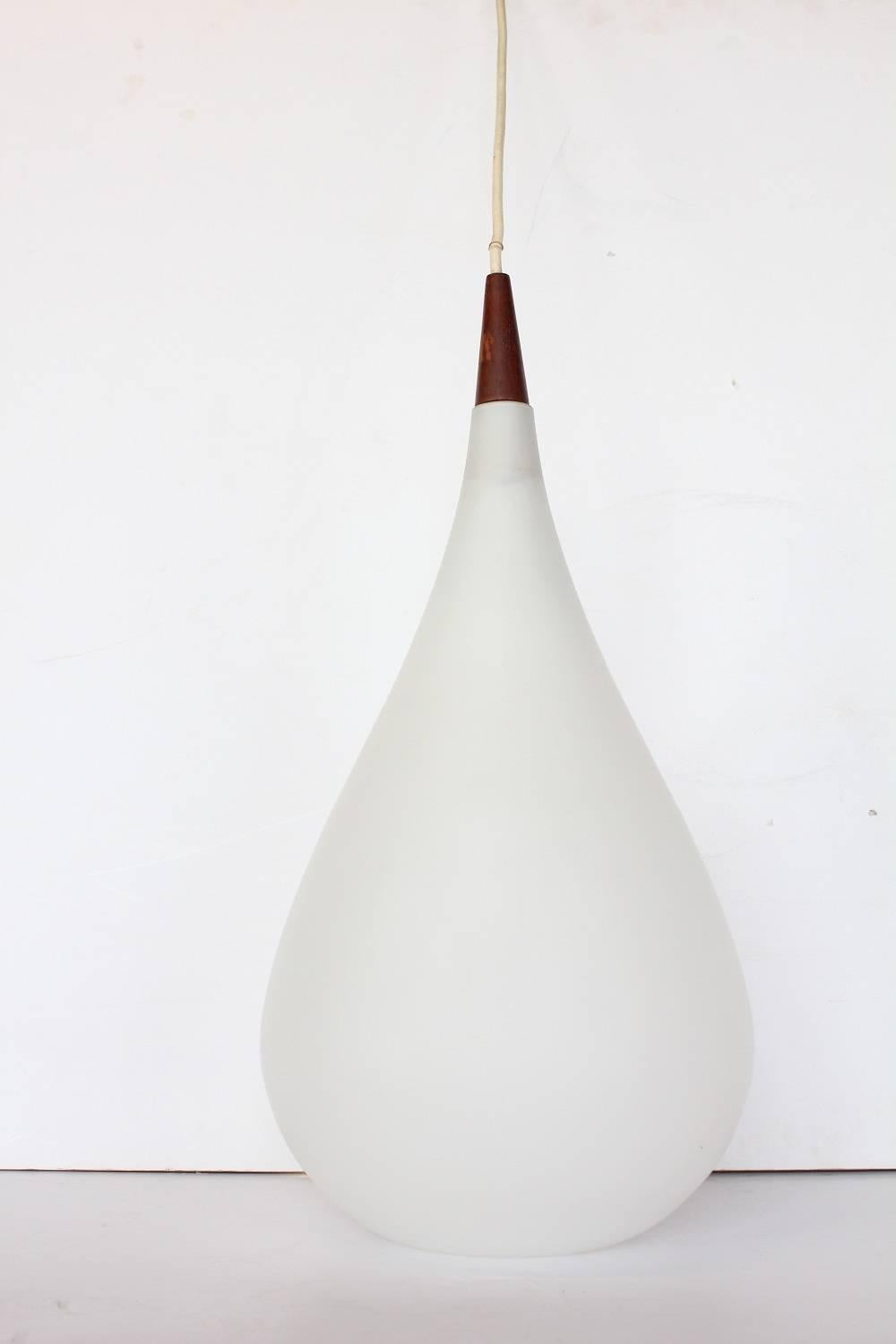 Large milk glass drop shaped pendant light by Holmegaard, three available. Listed price is for each light.