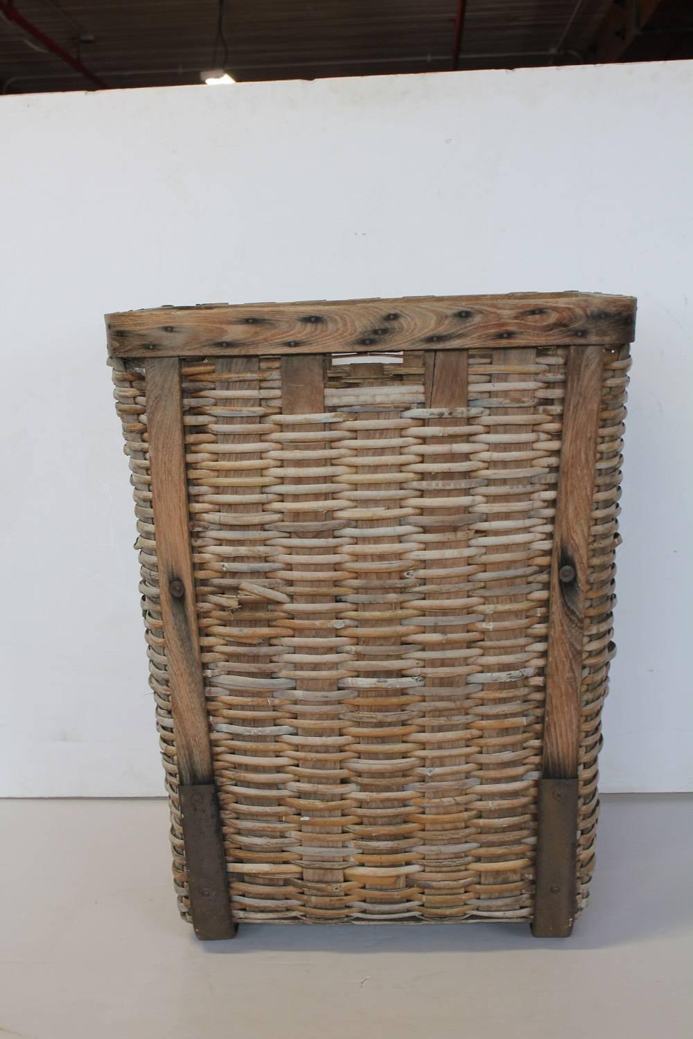 Large antique gathering basket with metal support.