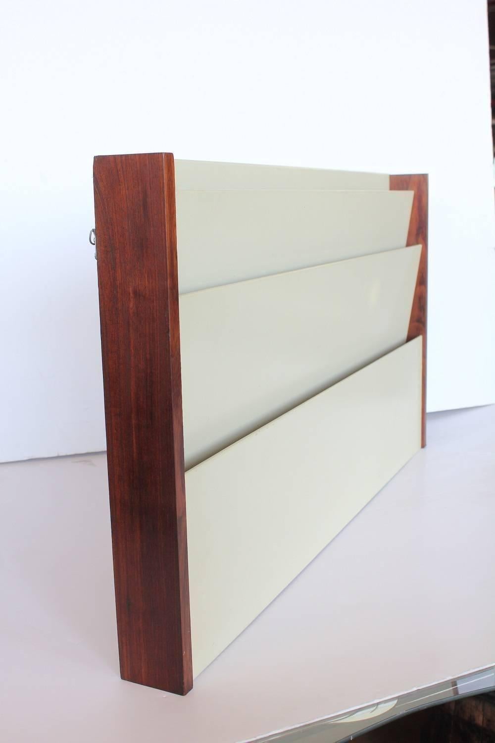 Wall mount magazine holder by Peter Pepper products. Walnut wood frame with white laminate dividers.