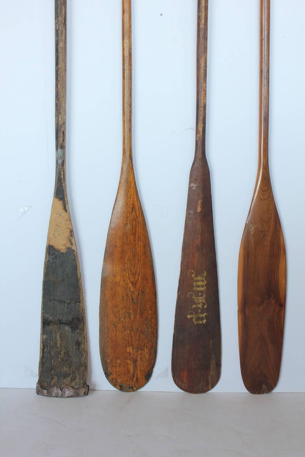 Antique Wooden Oars Collection. First on the right is copper tipped from 1884 with hand graved initial. Second on the right has hand painted initials. 