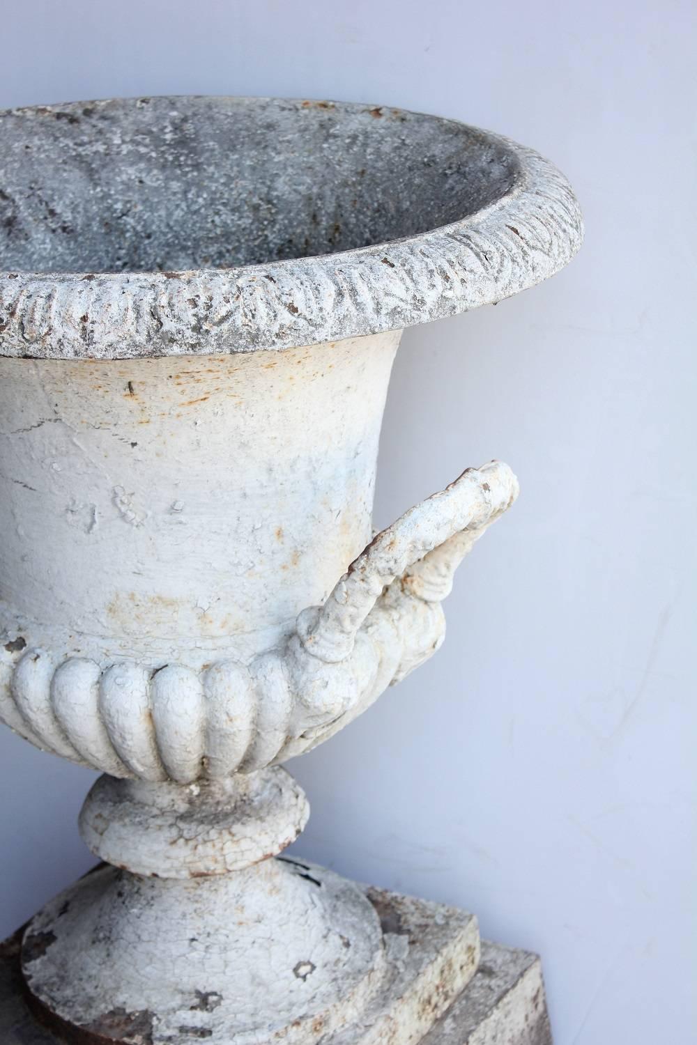 Antique 1800s neoclassical cast iron urn with pedestal.
