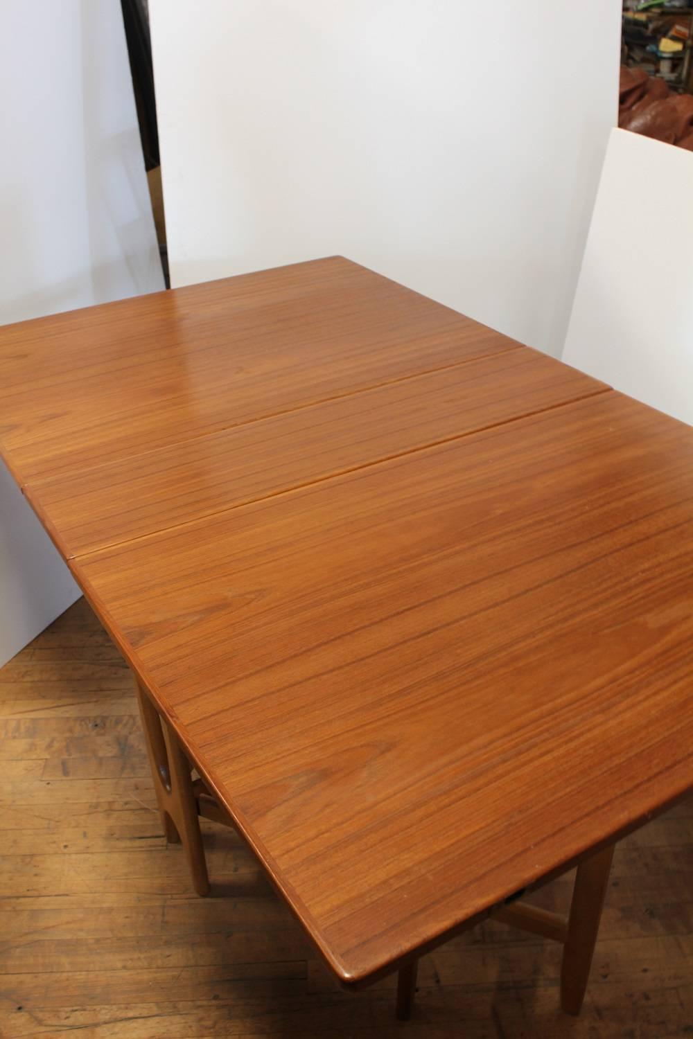 Midcentury Gateleg Folding Dinning Table, 2 available.  Dimensions: leaves folded down: 13.5″W x 35″D x 29″H, both leaves extended: 64″W x 35″D x 29″H
