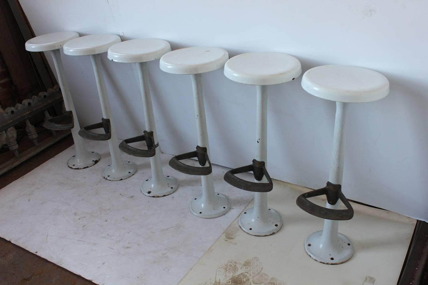 Antique soda fountain porcelain bar stools with original foot rests. They could be mounted to floor. Listed price is for one stool. Footrest H 12