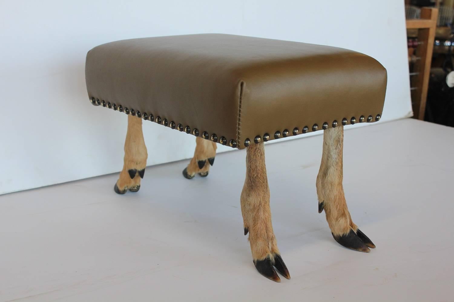 Antique leather and deer hoof footstool. New leather upholstery.