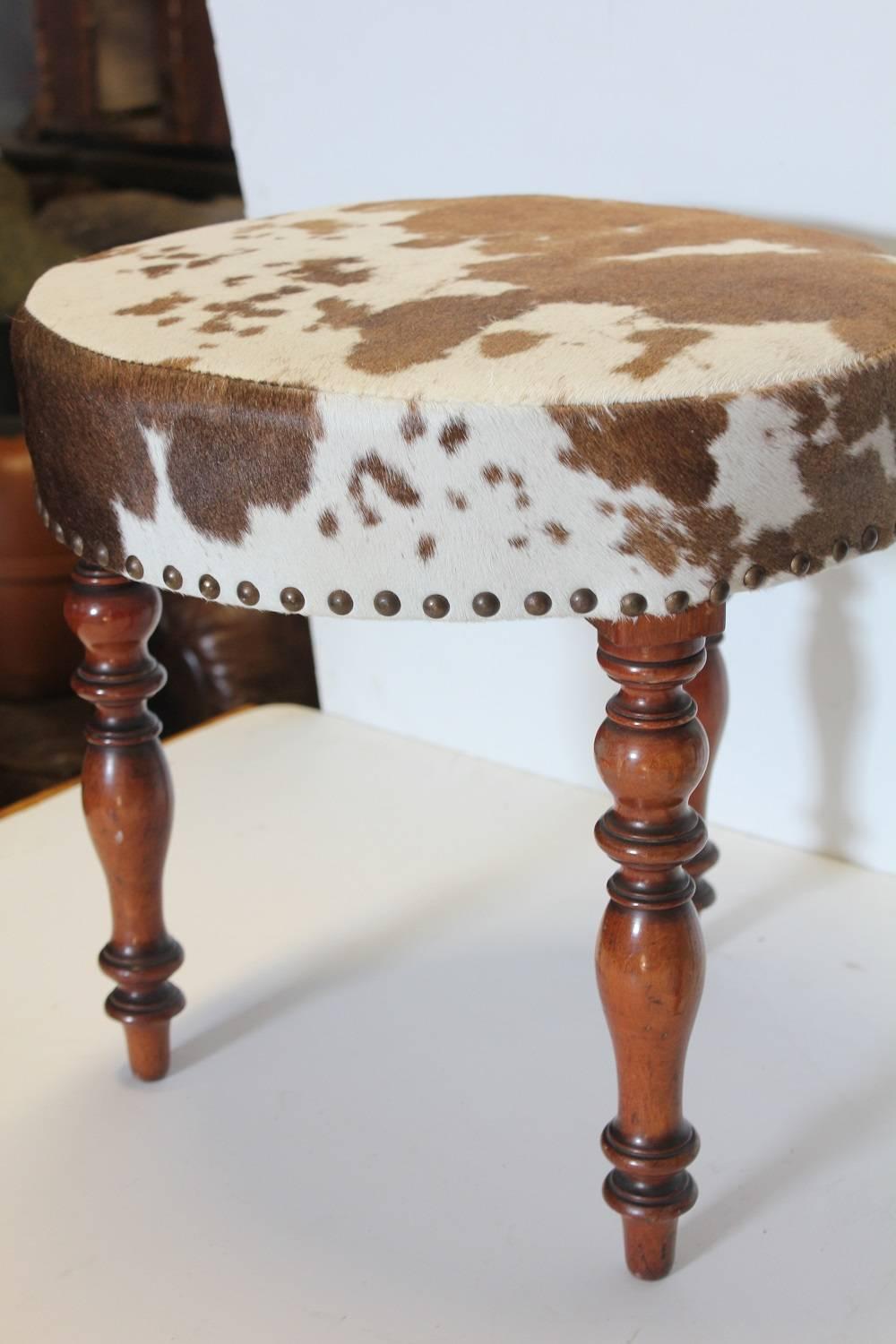 Antique English cowhide and wood stools. New cowhide upholstery.
