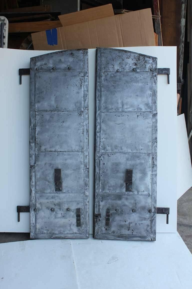 Antique distillery metal shutters that came from distillery from Kentucky. We have more available. Listed price is for one pair. They are refinished.