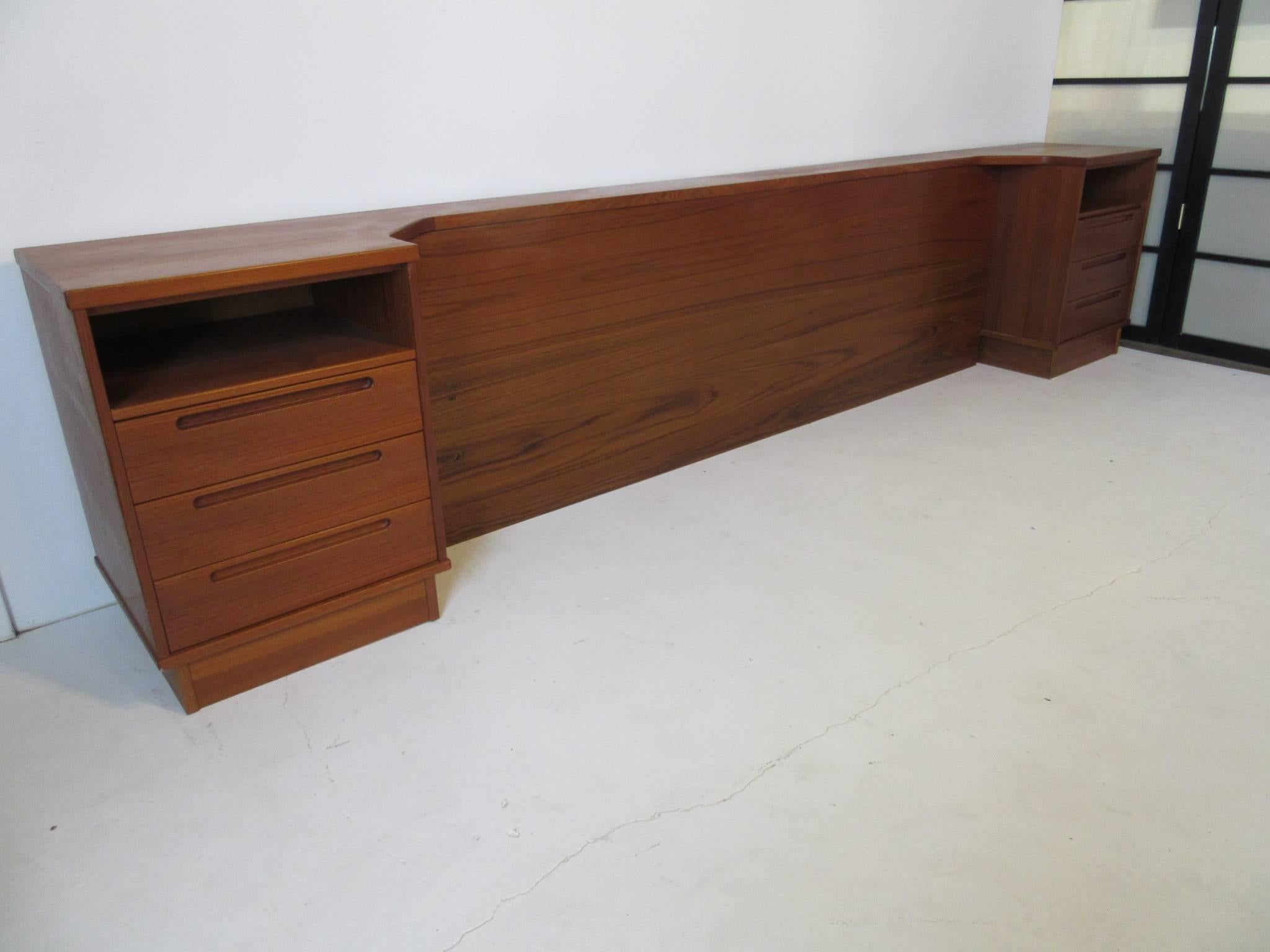 A Danish teak wood king-size platform bed set with built in nightstands, three drawers to each side and a built in headboard also two large storage drawers that are on each side of the lower platform. The whole thing comes apart and can be easily