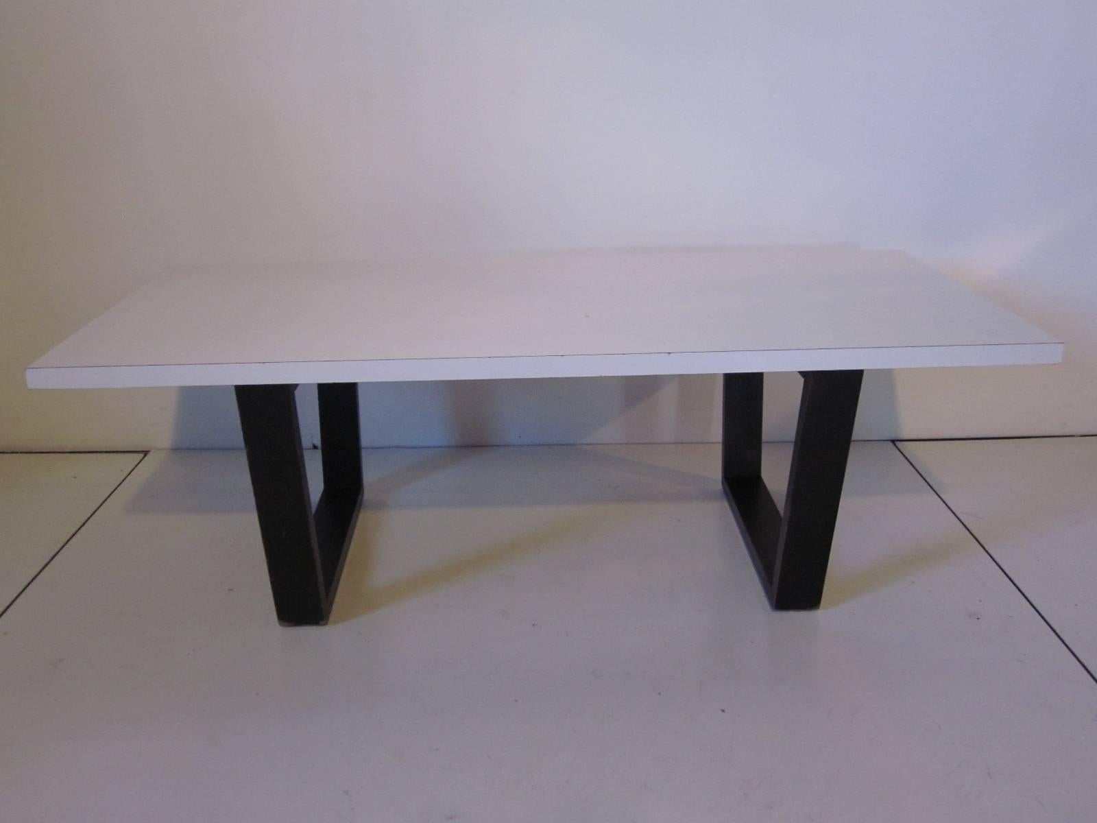 A rare George Nelson designed prototype coffee table or bench with black satin slat bench styled wood legs and white laminate top, the top is typical of the size, thickness and make up of other Herman Miller designs from the period. Purchased from