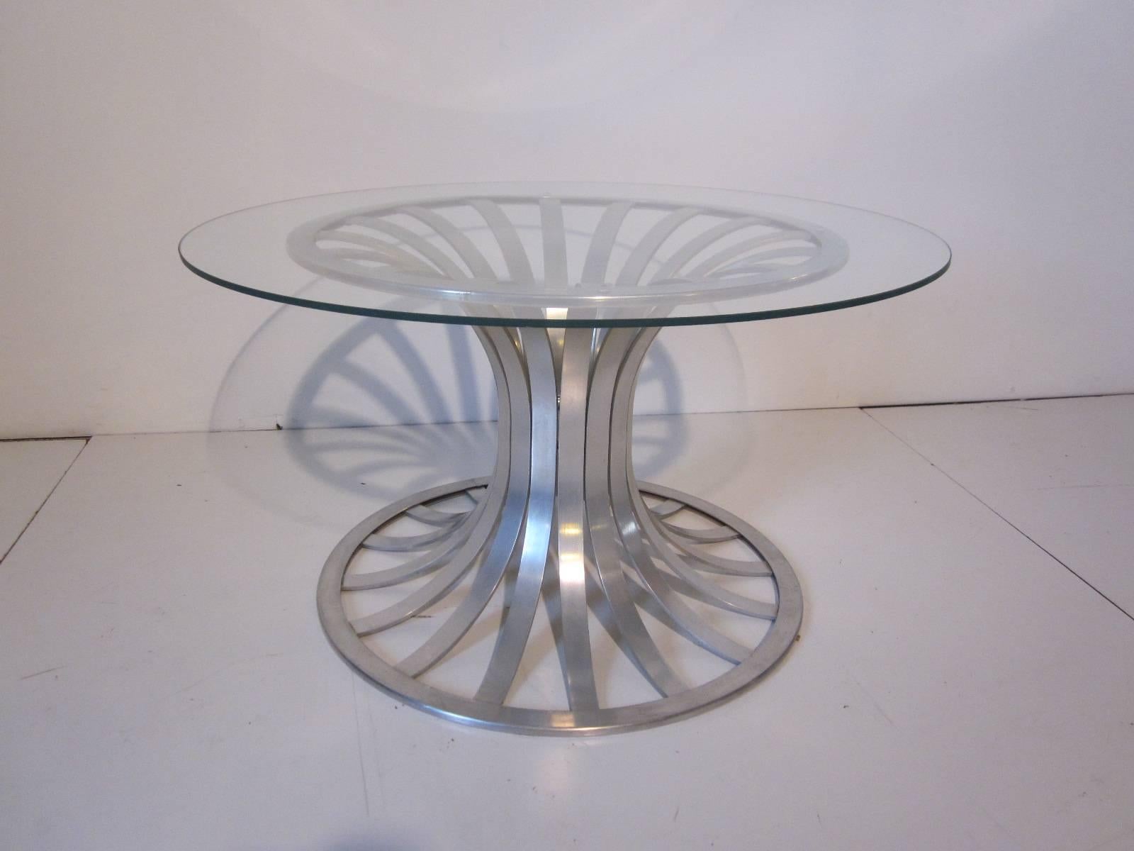 A smaller scale aluminum banded coffee or side table with glass top, manufactured by the Russell Woodard Furniture company. The size is just right for use as a coffee table in a small space or in a large area a side table.