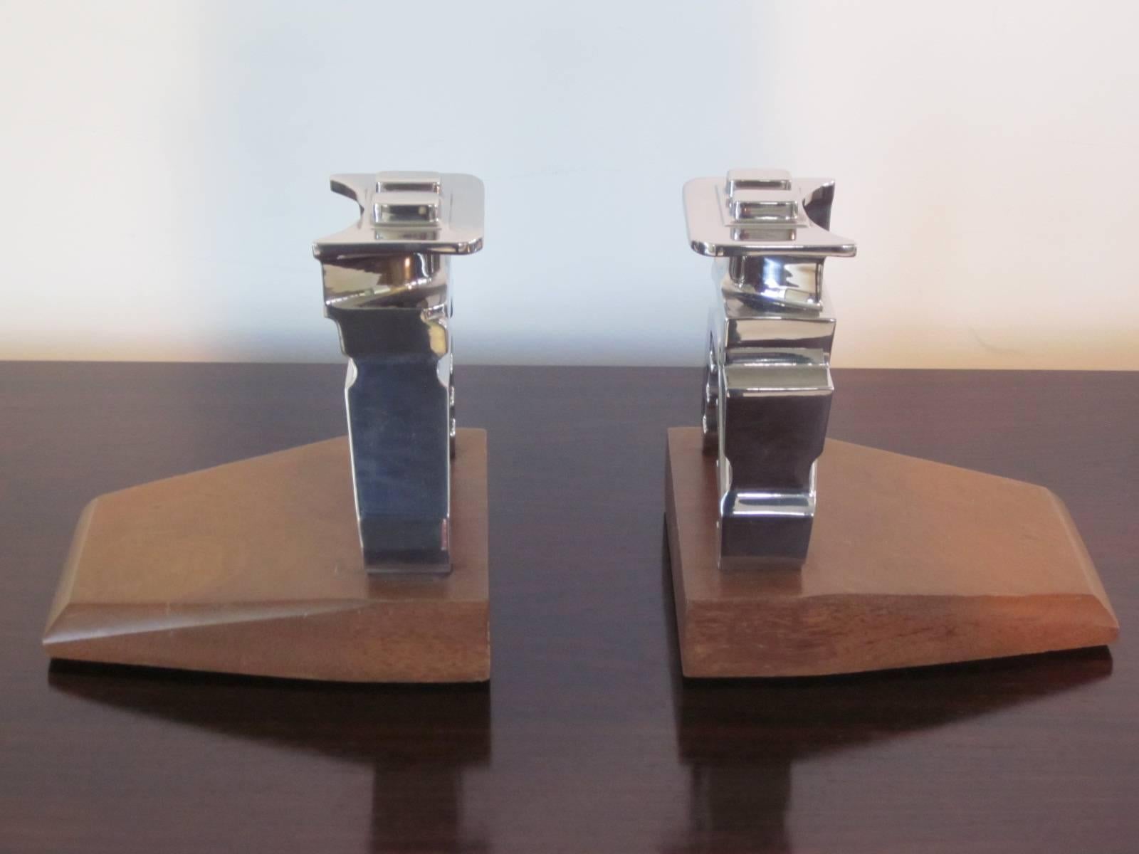 A pair of chromed steel Industrial automotive bookends mounted on two slabs of walnut, a great addition to the office shelve or desk. Parts are from a automotive jack unit from the 1930s.