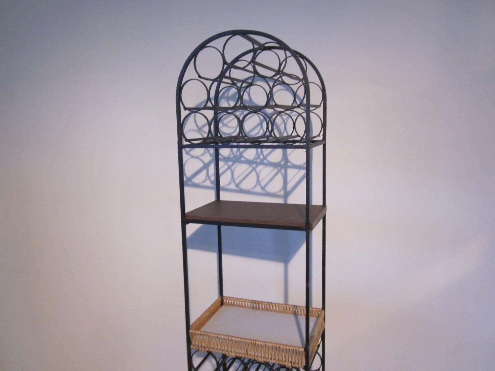 A black wrought iron wine rack which holds up to 39 bottles, has a woven shelve type basket for you bar tools or glasses and a upper laminated shelve for decanting, mixing and poring of your favorite beverage. Great for that tight spot in the den,