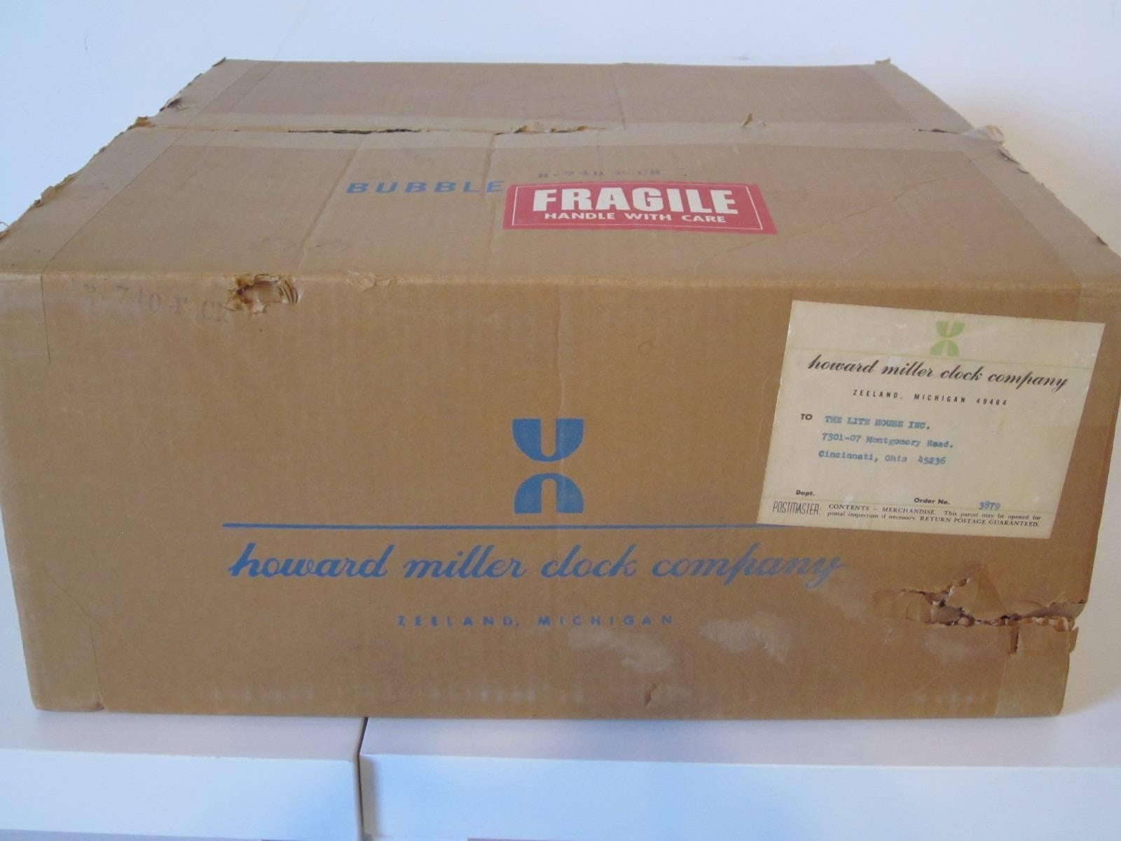 A Classic vintage George Nelson hanging bubble light with original ceiling plate and box, retains the label to the light and cardboard packing. Manufactured by the Howard Miller Lighting Company, Zeeland Michigan.