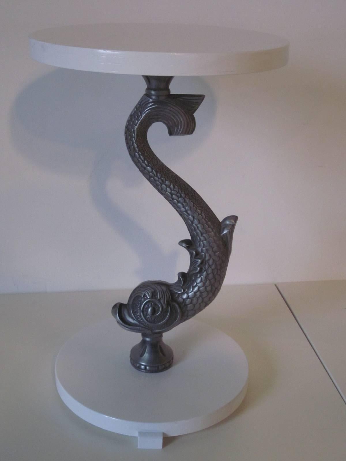 A pair of pedestal end tables with painted stain white wood tops and cast metal fish columns in pewter tone, in the style of Art Deco, Miami.