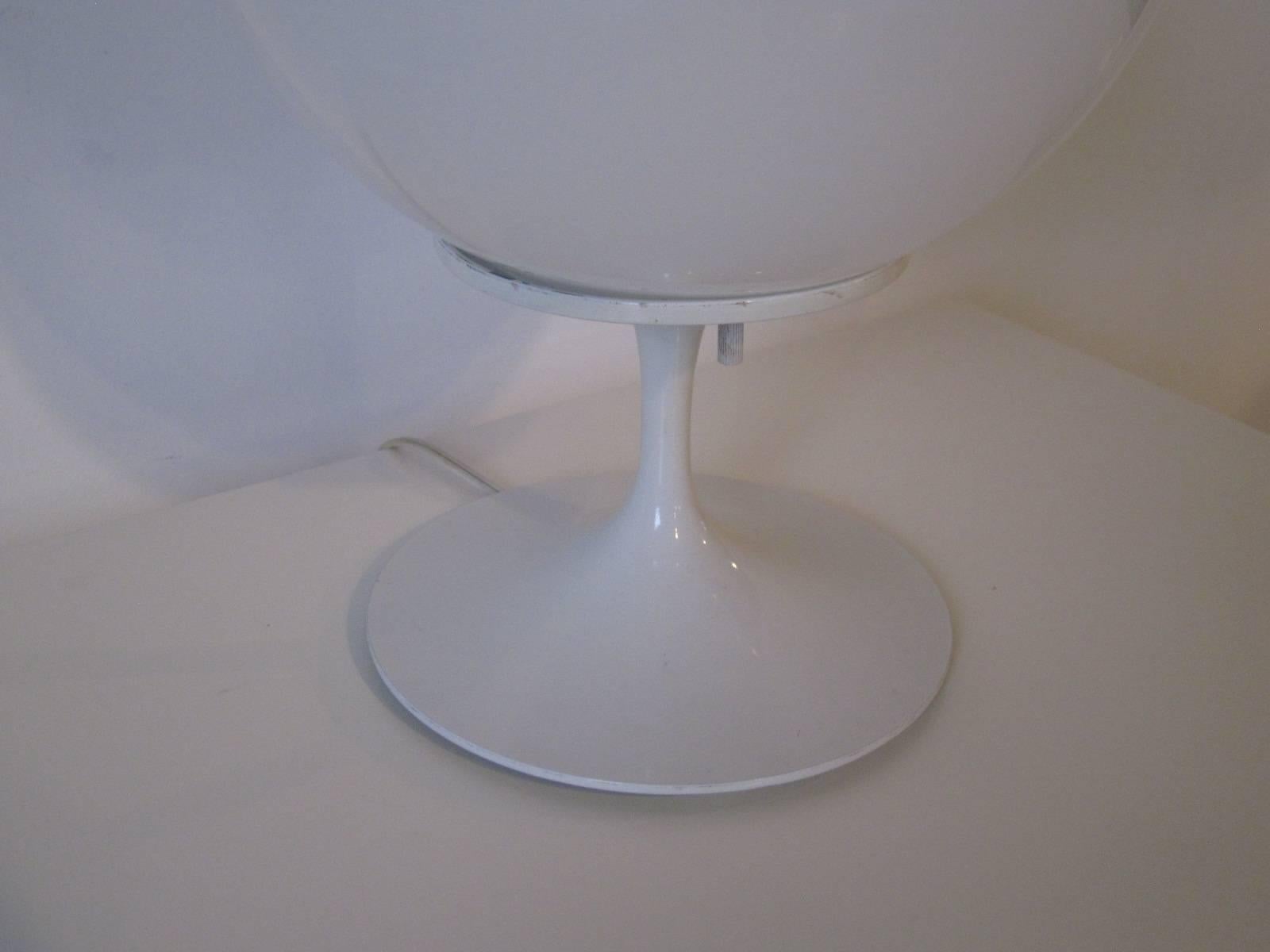 A white tulip table lamp with white round globe top manufactured by the Stemlite and Design Line Company.
