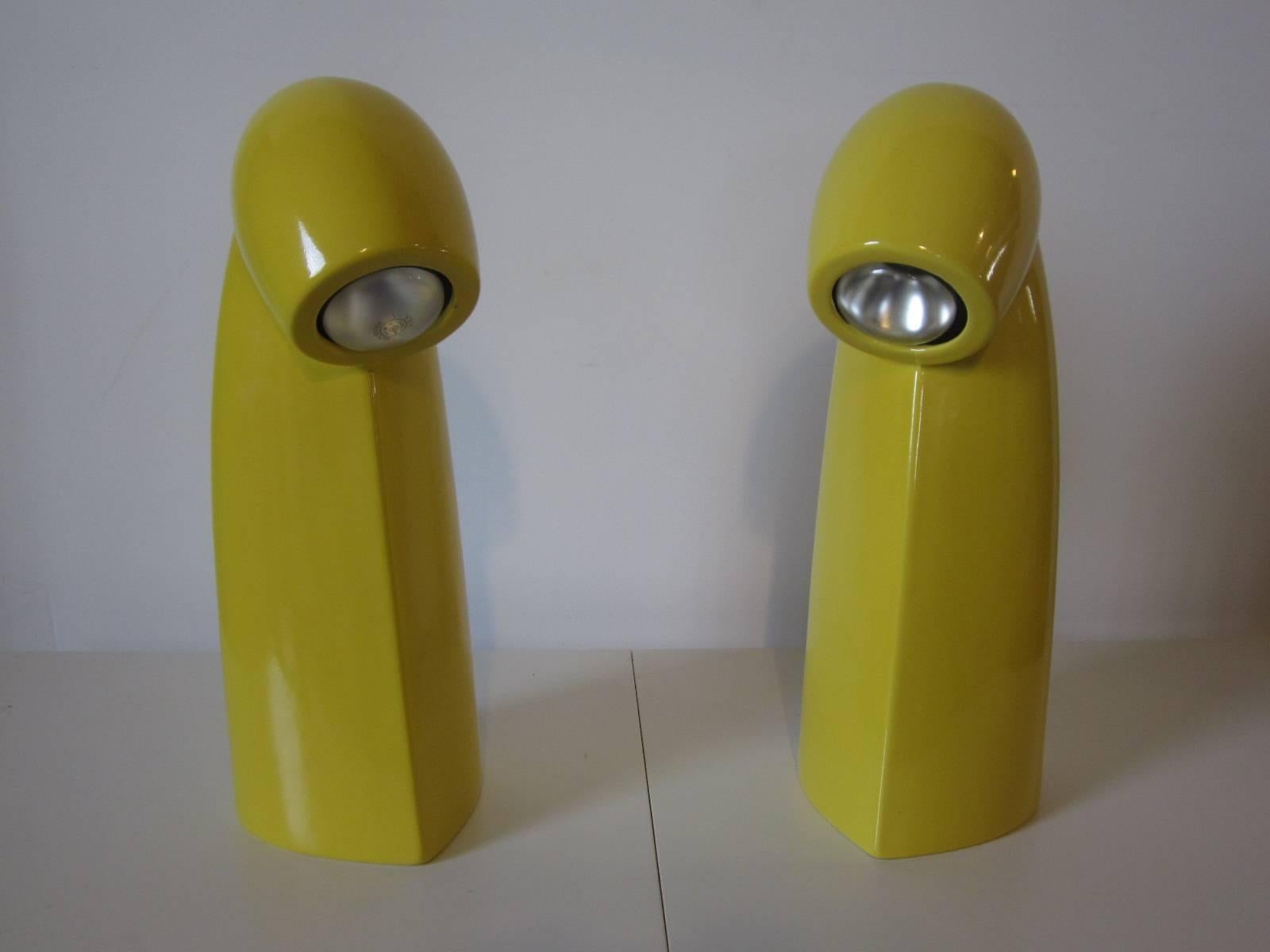 A pair of bright yellow ceramic pottery periscope styled table or desk lamps with upper switch to the back of the head and retractable push in cord to adjust the length. A rare to find matching pair in as new condition nos 