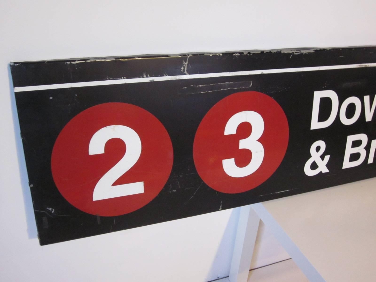 A original painted metal two sided New York Subway sign for route 2-3 Downtown and Brooklyn in black and white with red graphics. Taken down during reconstruction in the late 1970s.