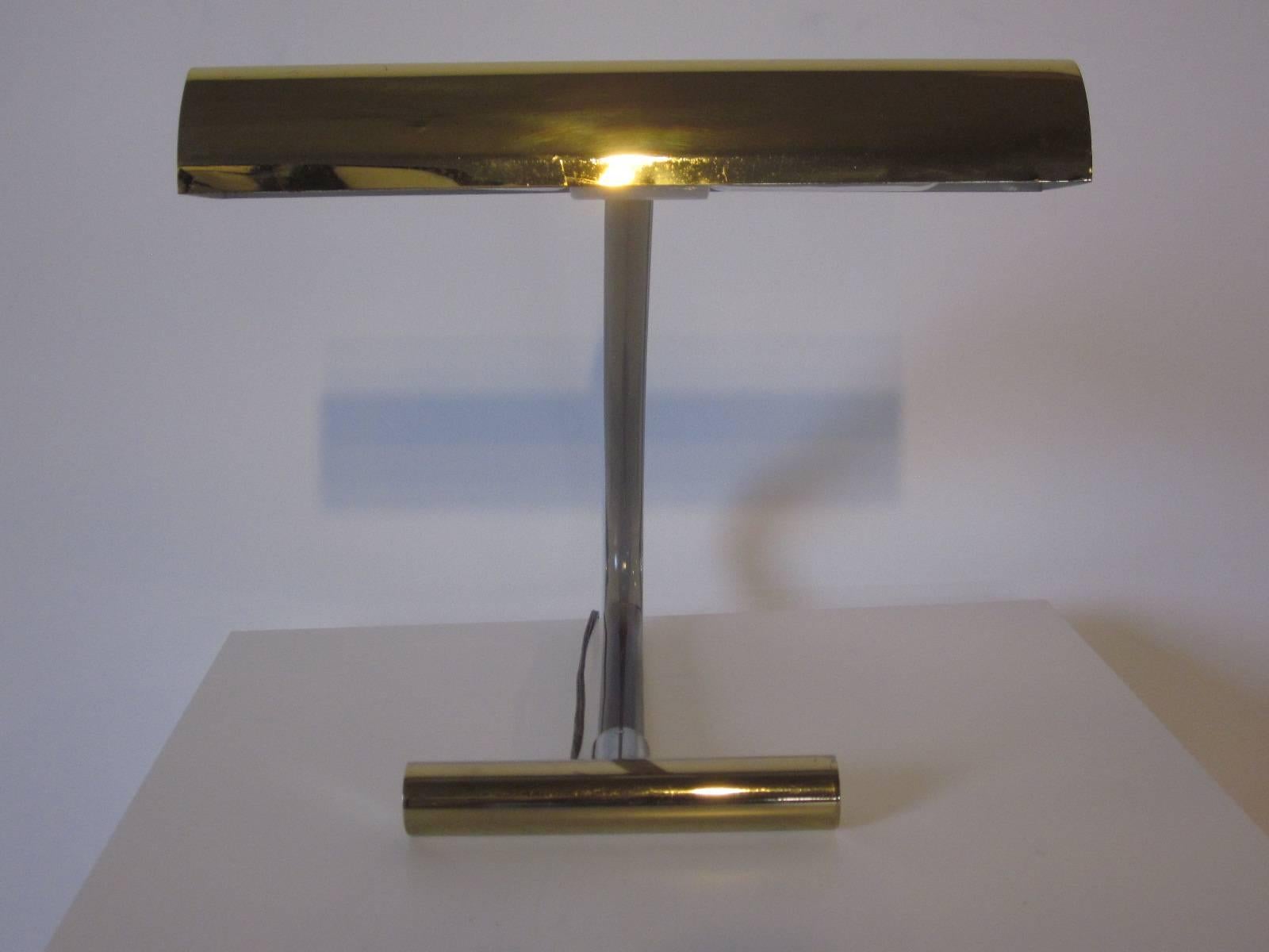 A Peter Hamburger desk lamp with a very slightly smoked Lucite arm, brass shade and base with chrome details, a sophisticated and stylish piece for home or office .