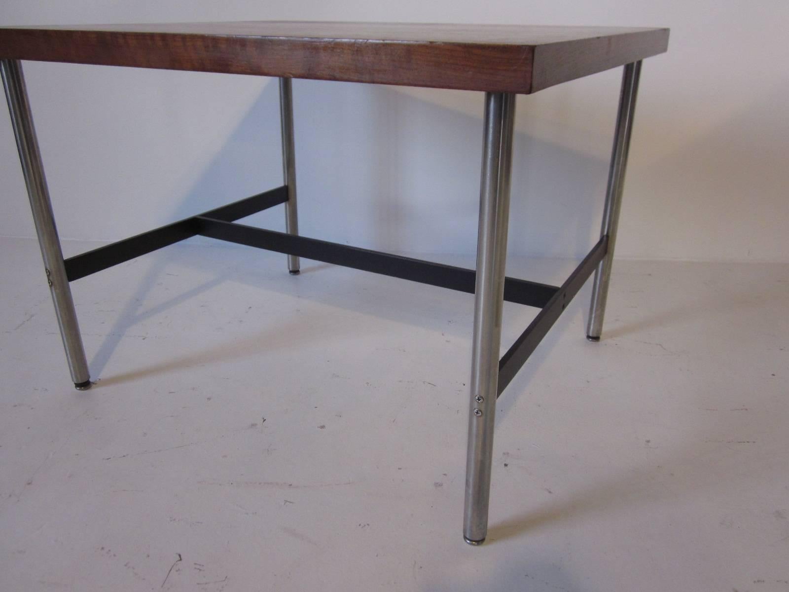 A hard to find Nelson walnut topped side table with brushed stainless steel legs and satin black metal stretchers manufactured by the Herman Miller Furniture Company.