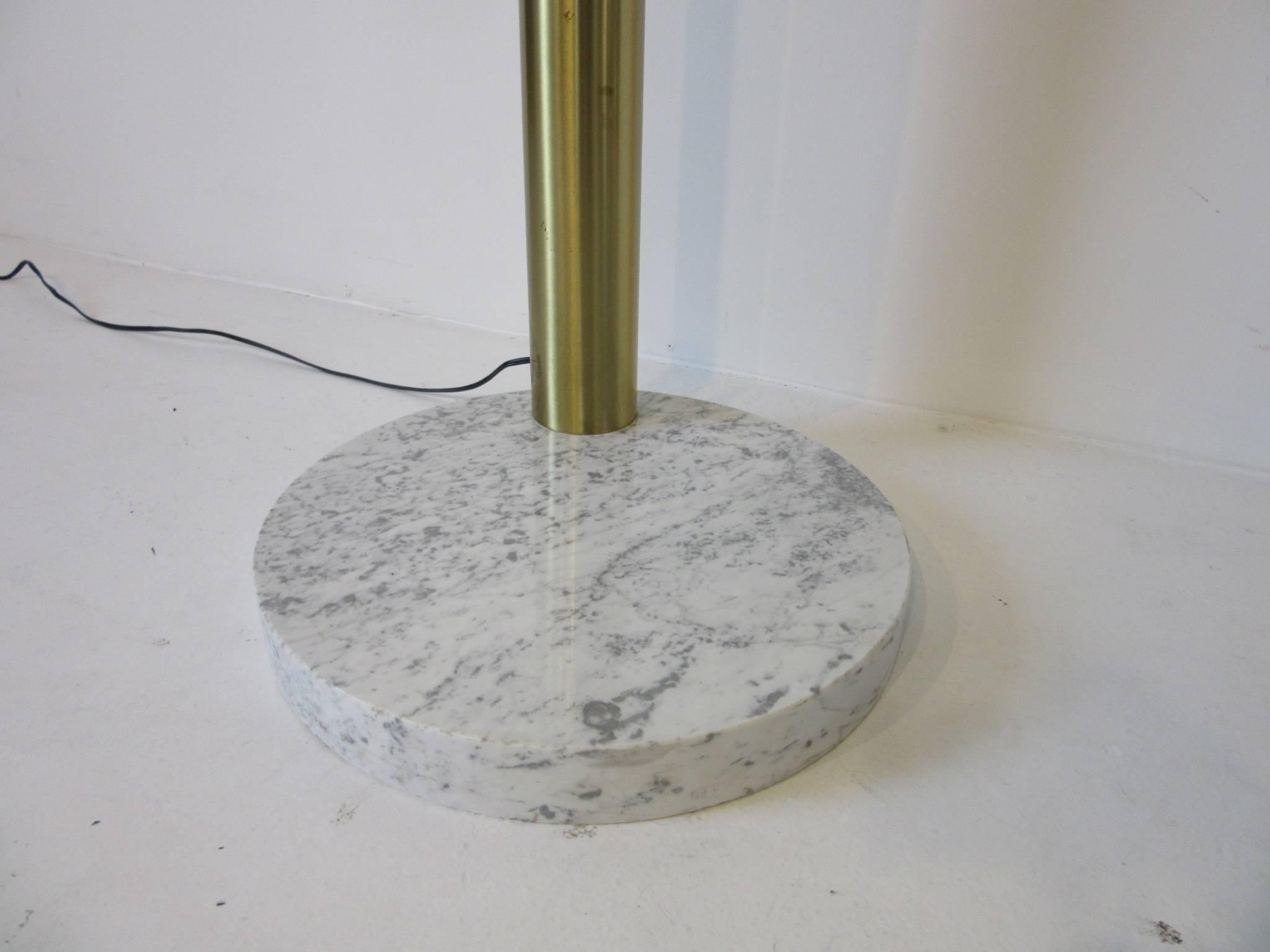 A six adjustable armed spray arc floor lamp with cylinder styled light fixtures, round white veined thick marble base and finished in a brushed brass with foot switch.