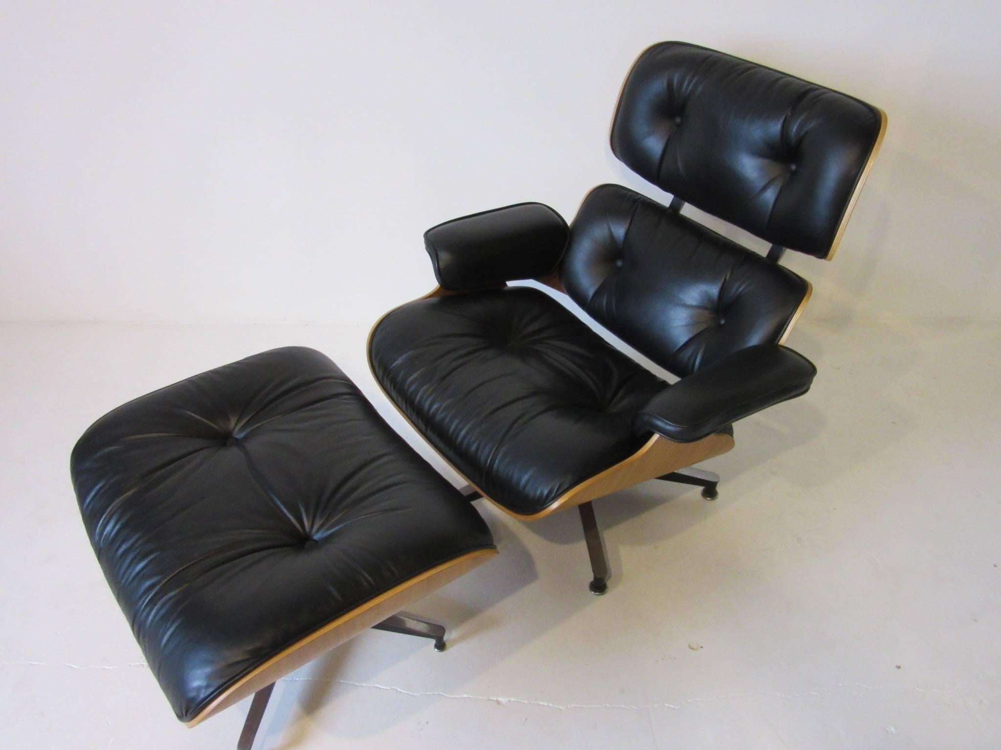 A soft and supple black leather Classic Eames 670 lounge chair with matching ottoman in walnut with cast aluminum legs. This iconic chair defines the style of Mid-Century as we know it today. Retains the manufacturers tags and is in wonderful