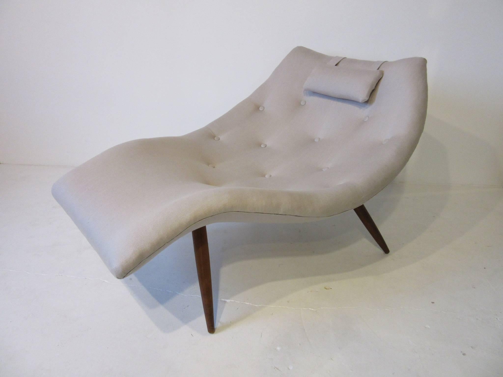 A sculptural Adrian Pearsall chaise longue chair designed at the top of his game with sensual curves forming a womb like space for relaxing. With adjustable head cushion, button top cushion upholstered in Fine Italian linen all sitting on solid